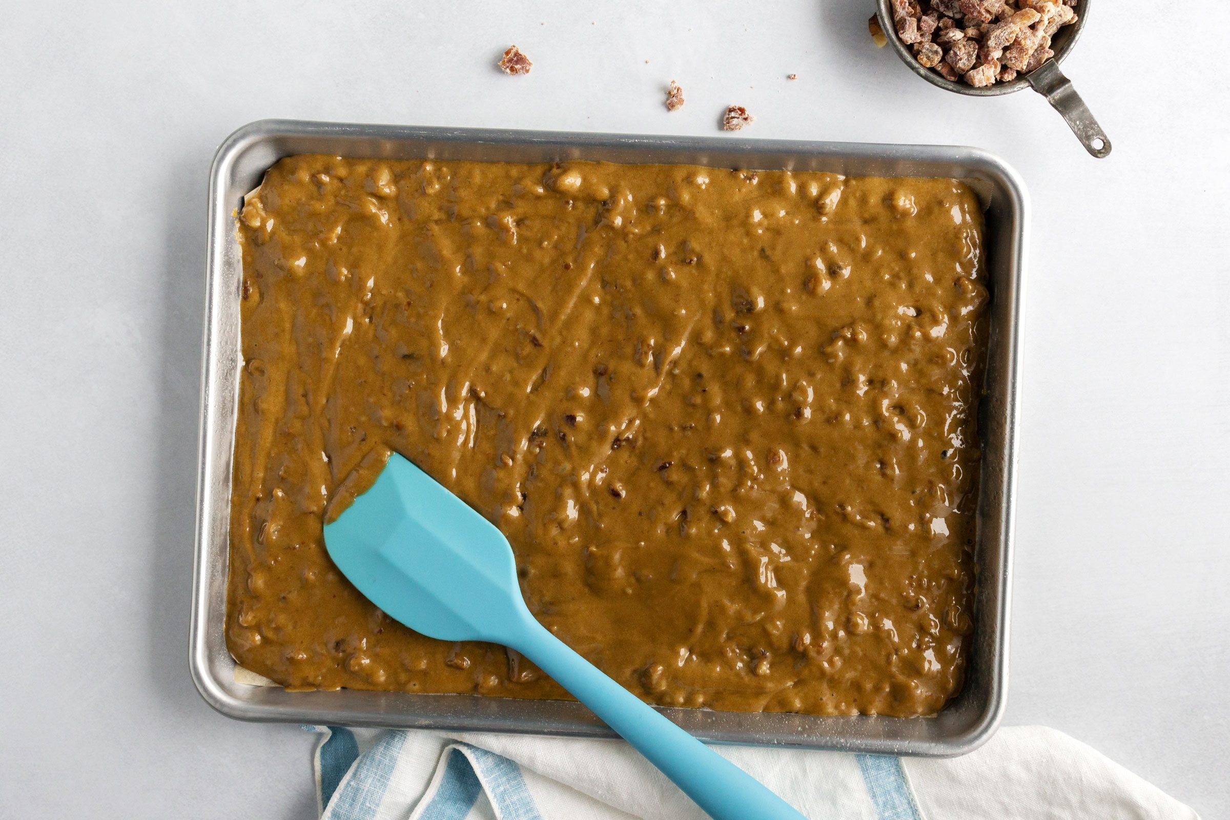 spreading the Lemon Frosted Fruit Bars batter into a pan