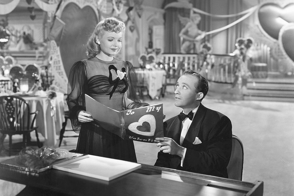 Linda Mason (Marjorie Reynolds) joins Jim Hardy (Bing Crosby) at the piano to look at a Valentine in his nightclub the Holiday Inn in the 1942 musical Holiday Inn. (Photo by �� John Springer Collection/CORBIS/Corbis via Getty Images)