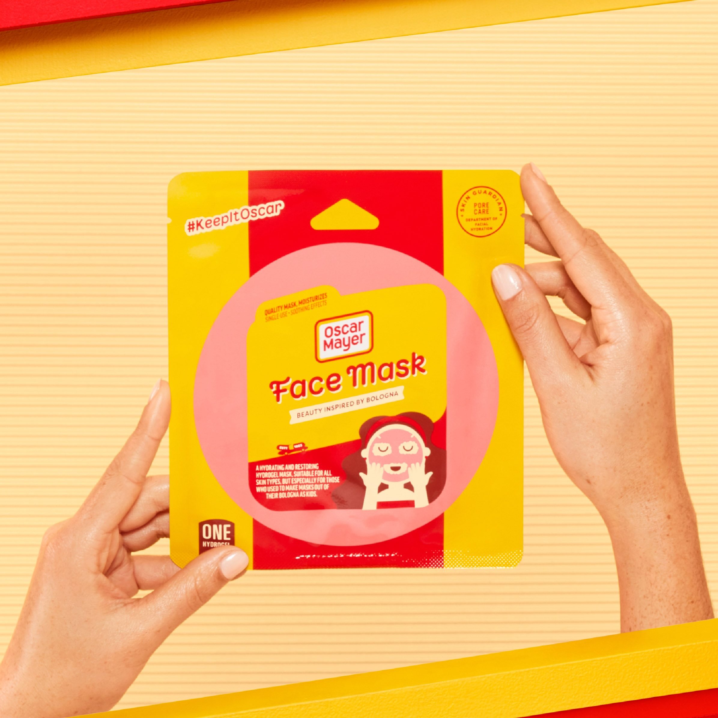 hands holding the packaging for the oscar mayer bologna face mask