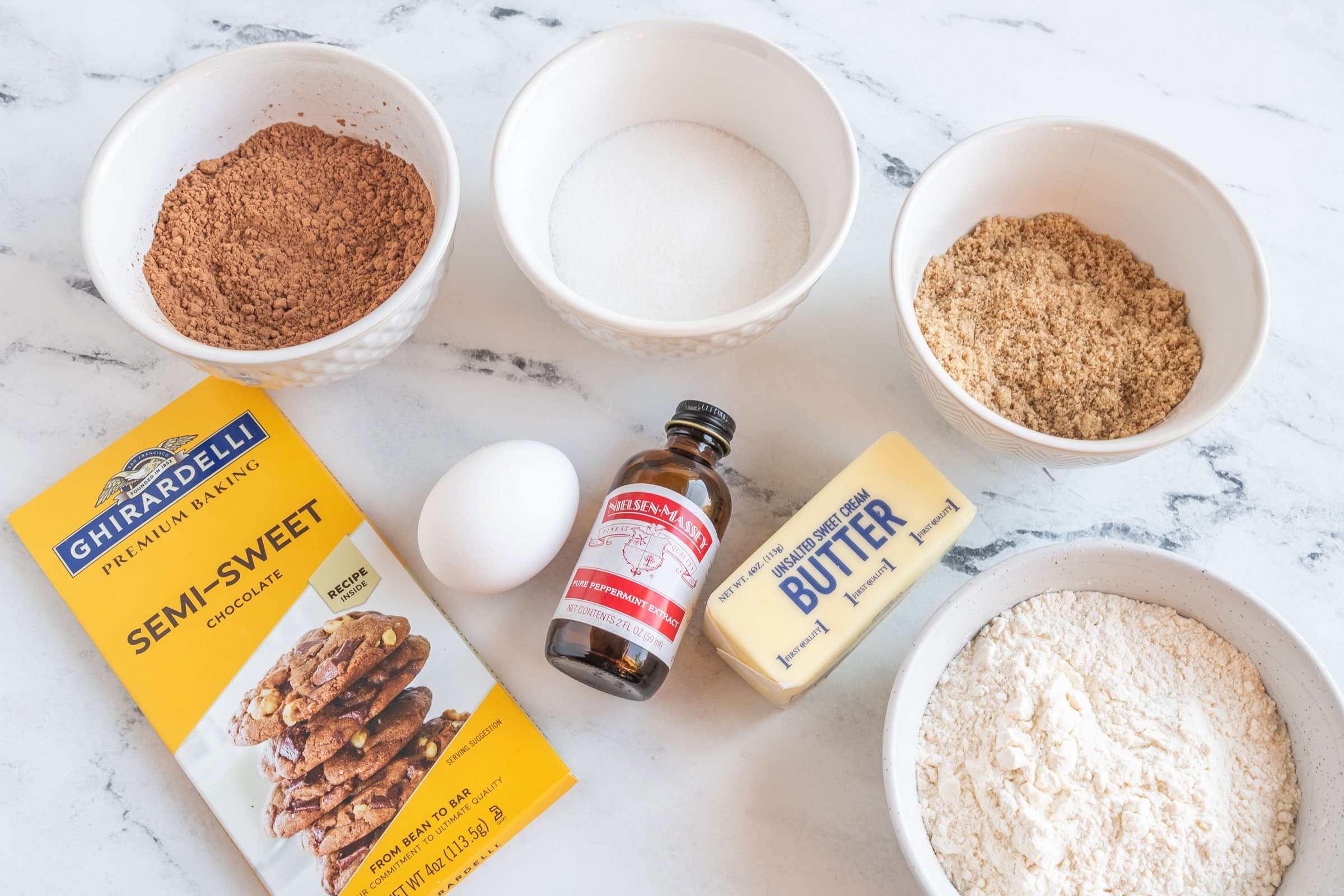 Homemade Thin Mints ingredients laid out on a marble kitchen counter