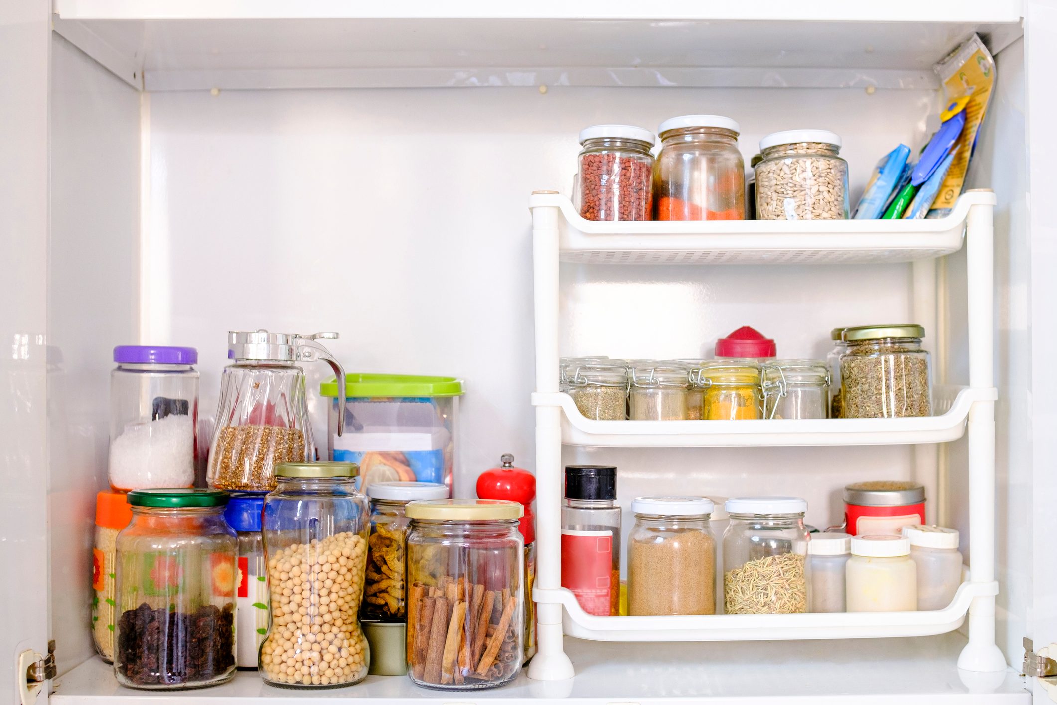 View of a well-stocked pantry with varieties of cans and pots