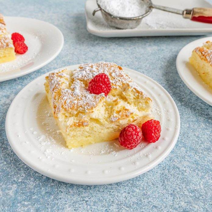 Magic Cake on a plate topped with raspberries