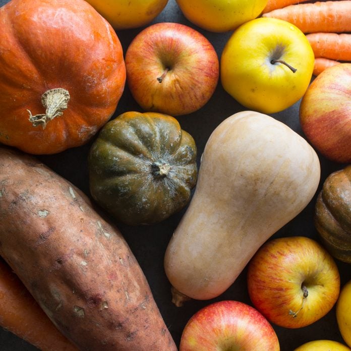 Vibrant colors of fresh autumn fruits and vegetables.