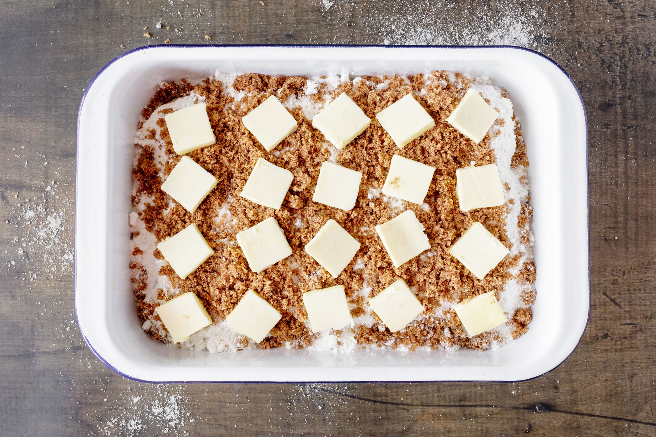 more layers being added to the cinnamon dump cake pan before baking