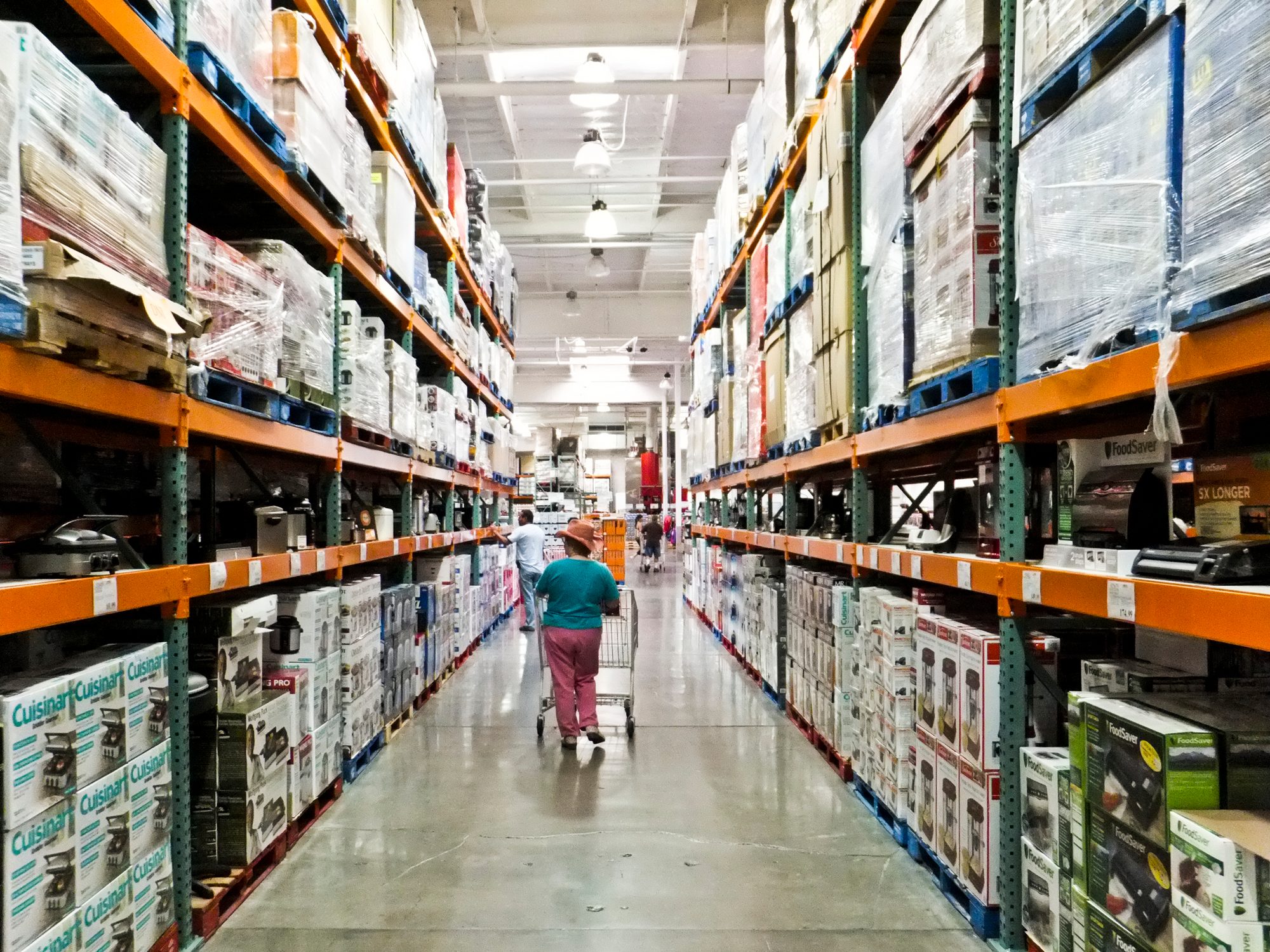 shopper walks aisles of Costco warehouse retailer