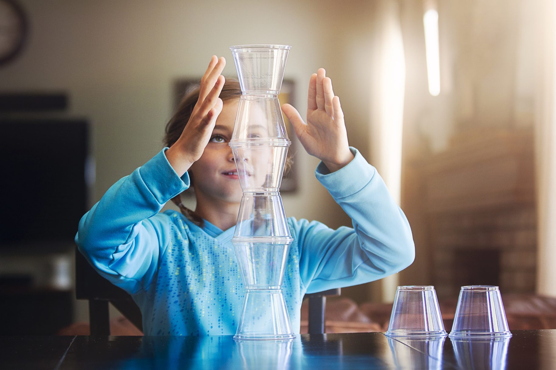 Girl stacking plastic cups