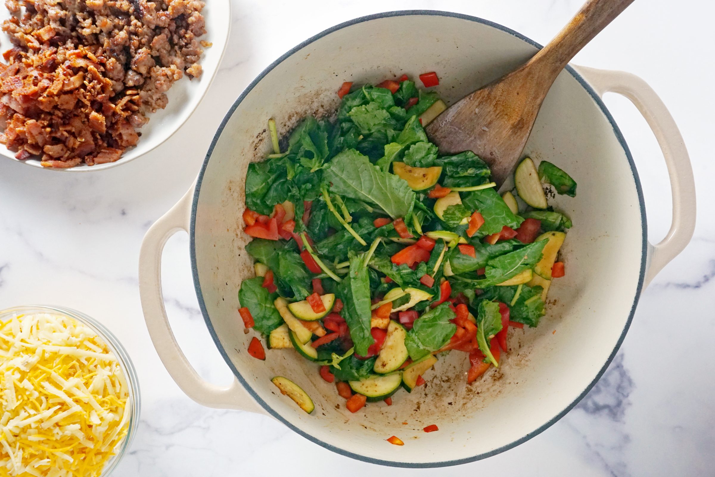 sauté vegetables in a large dutch oven pot with a wooden spoon