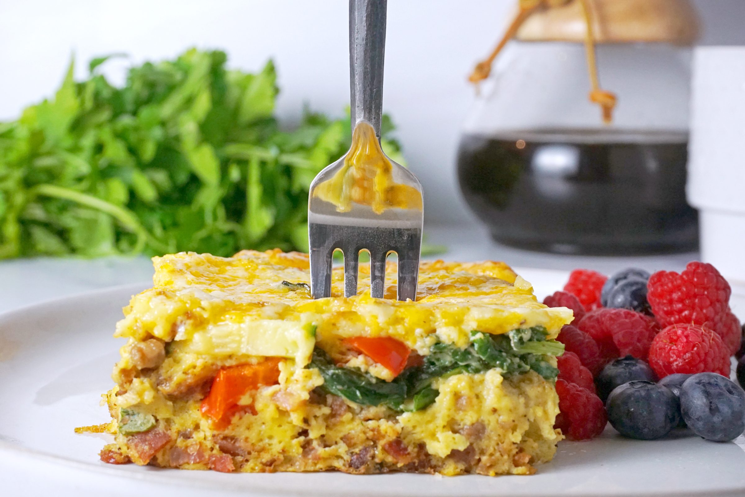 slice of Keto Breakfast on a plate with berries to the side