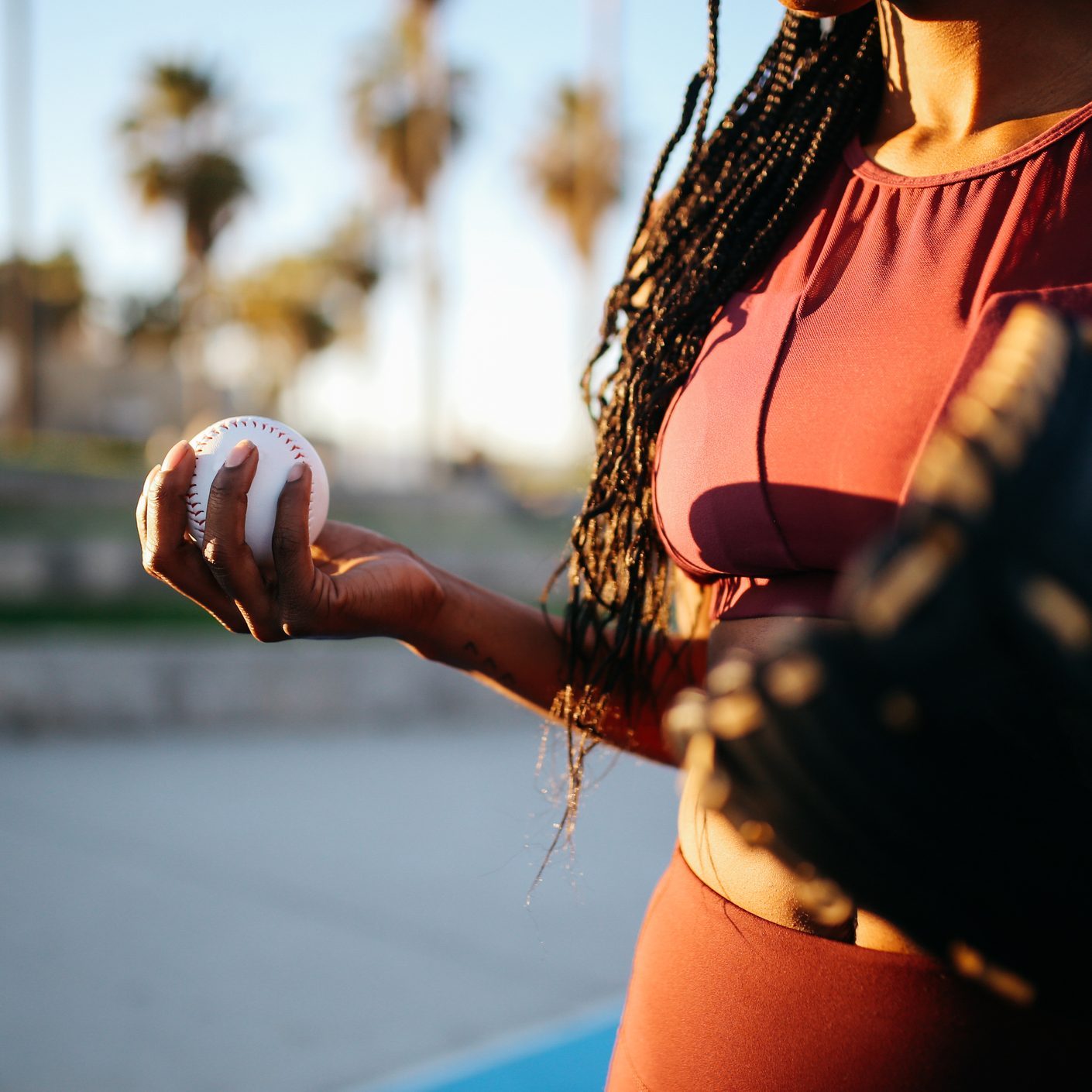 Young woman practicing baseball near Venice beach, California