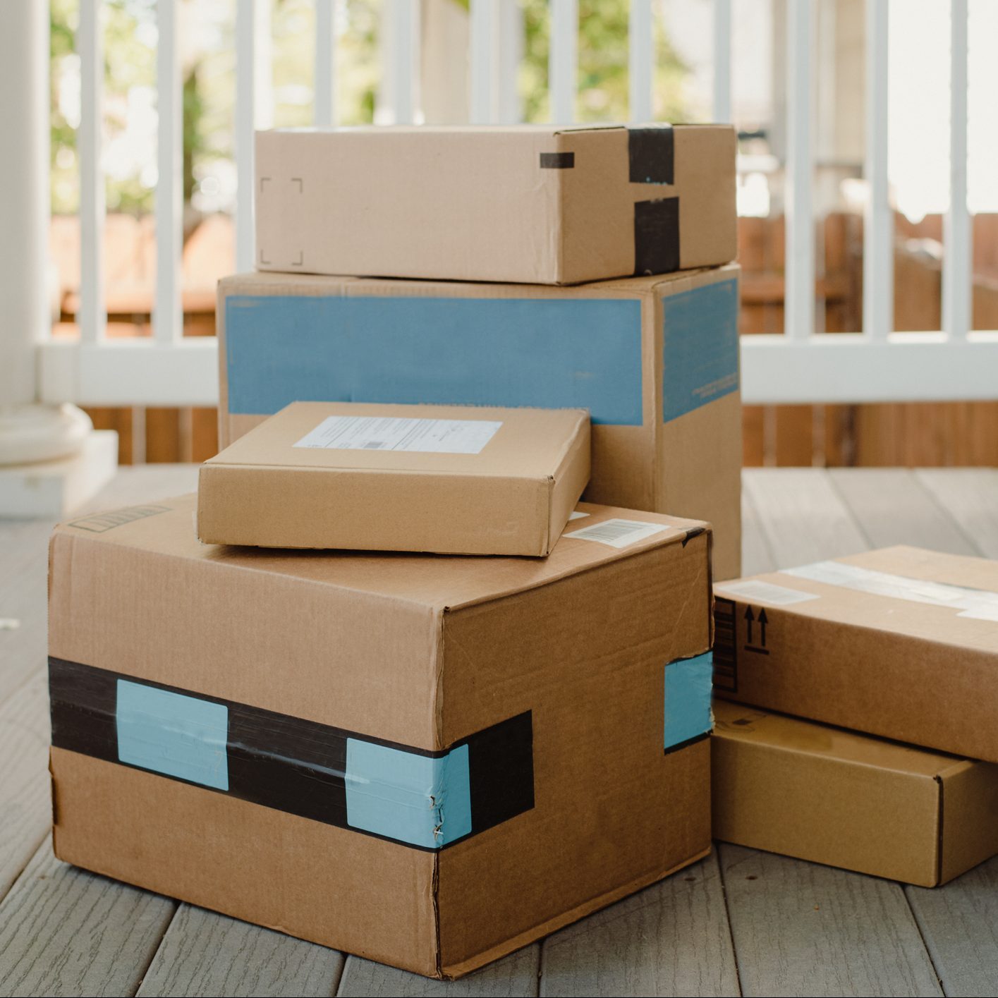 Stack of packages on front porch after mail delivery