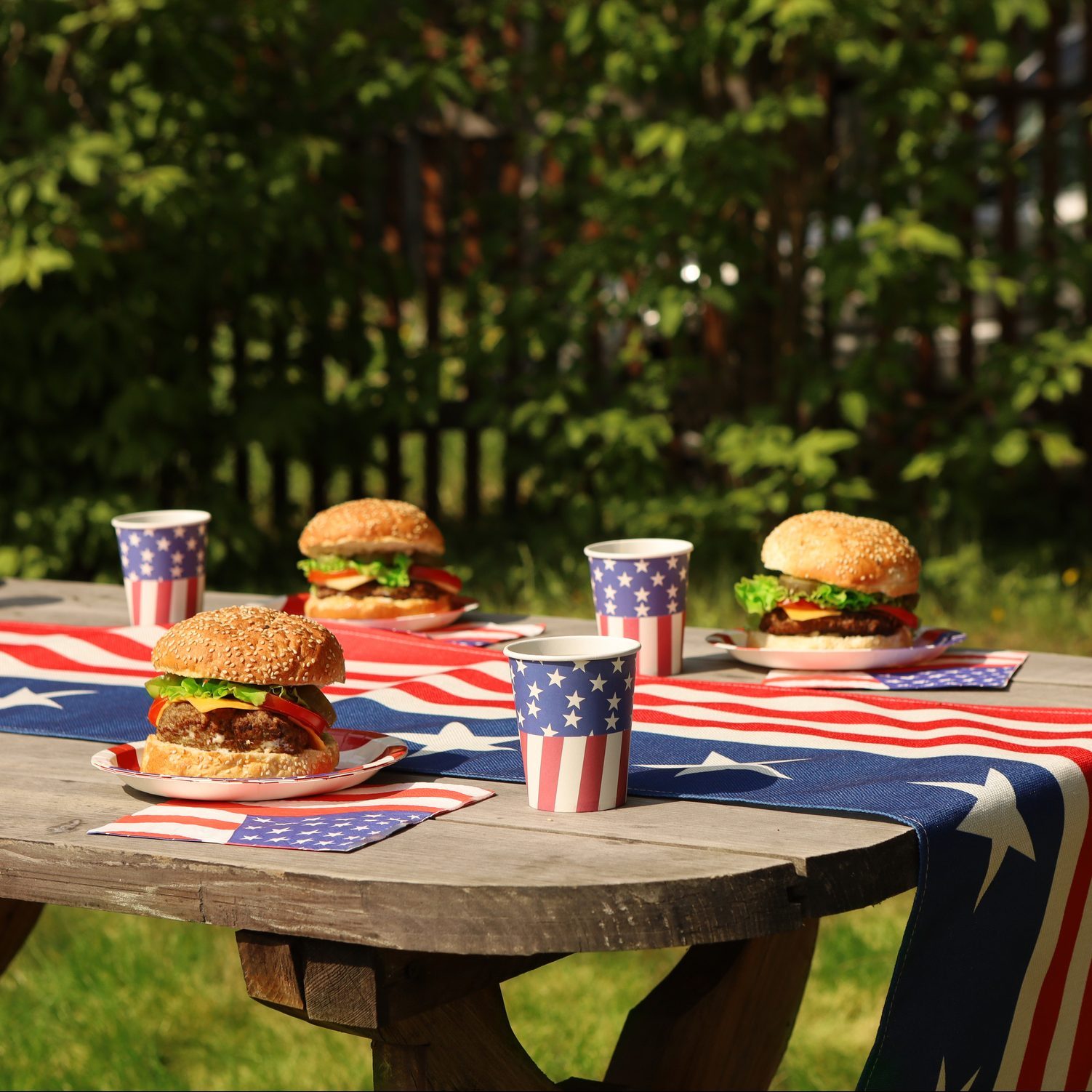 Fourth of July, American food. Above view table scene on white wood.