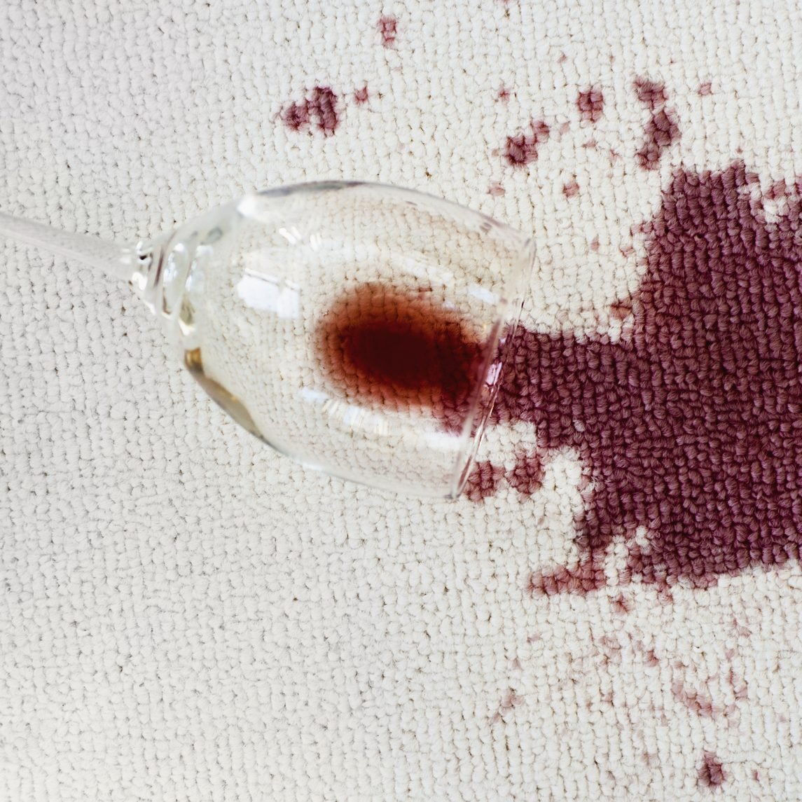 Close up of spoiled red wine on white background