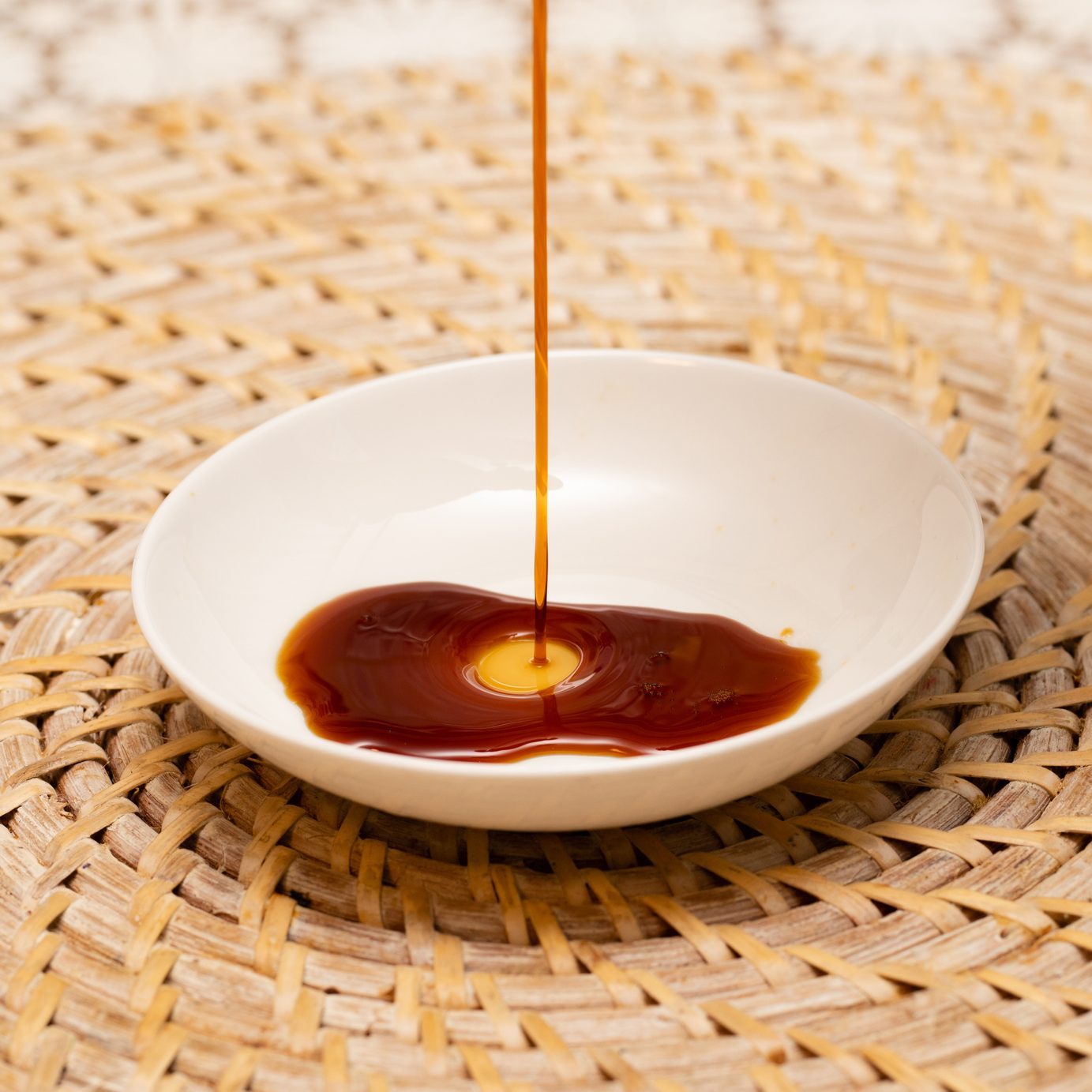 Soy sauce poured on a small white plate