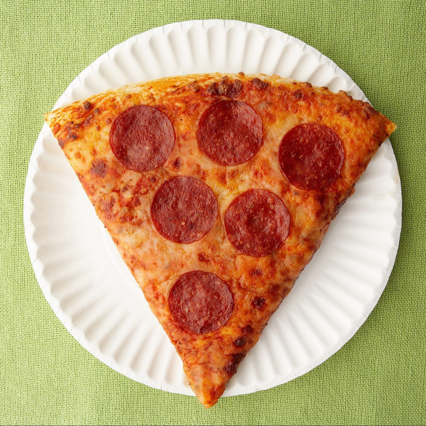 Pepperoni pizza on paper plate