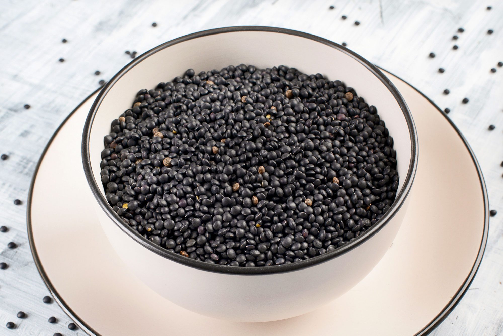 Black Beluga Lentil Seeds In A Ceramic Bowl On Ceramic Plate