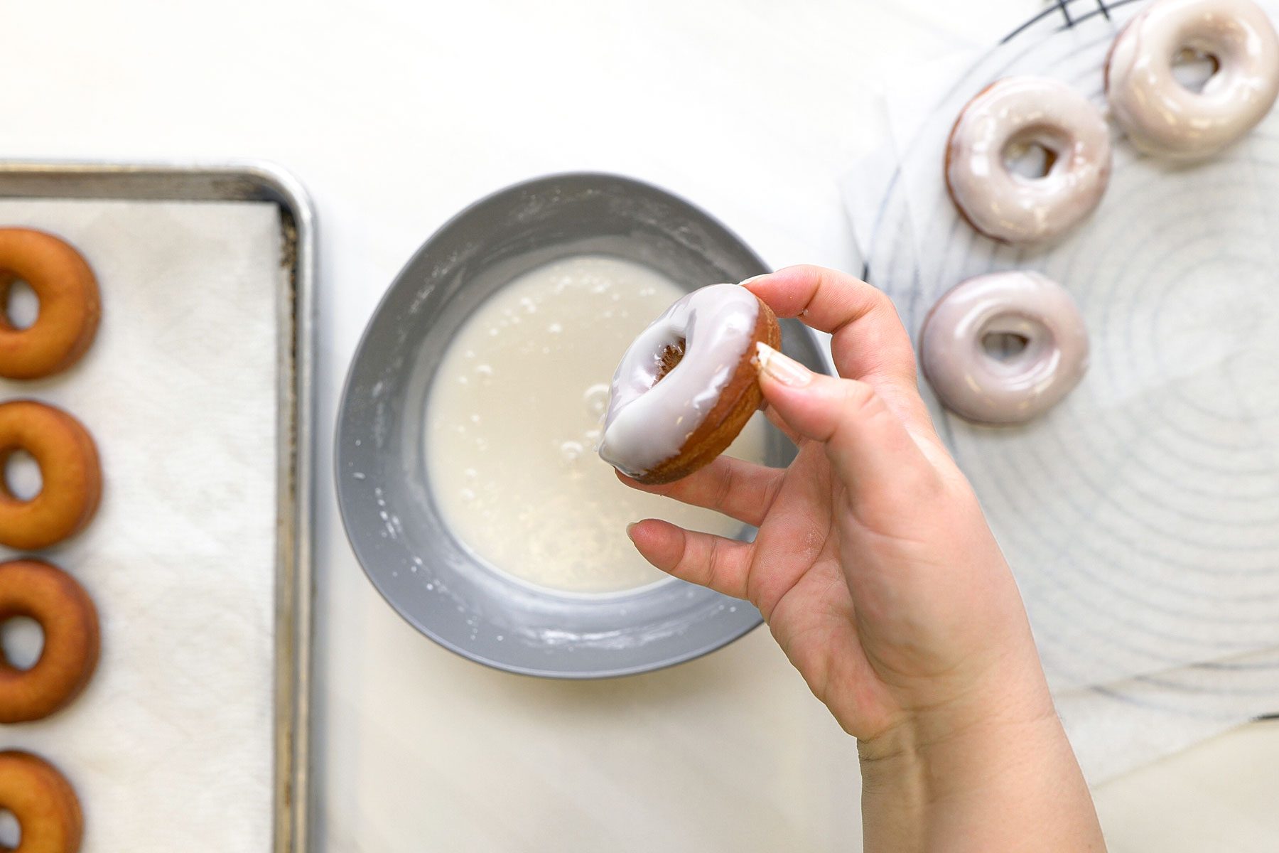 Dipping the doughnuts into the mixture in a large bowl