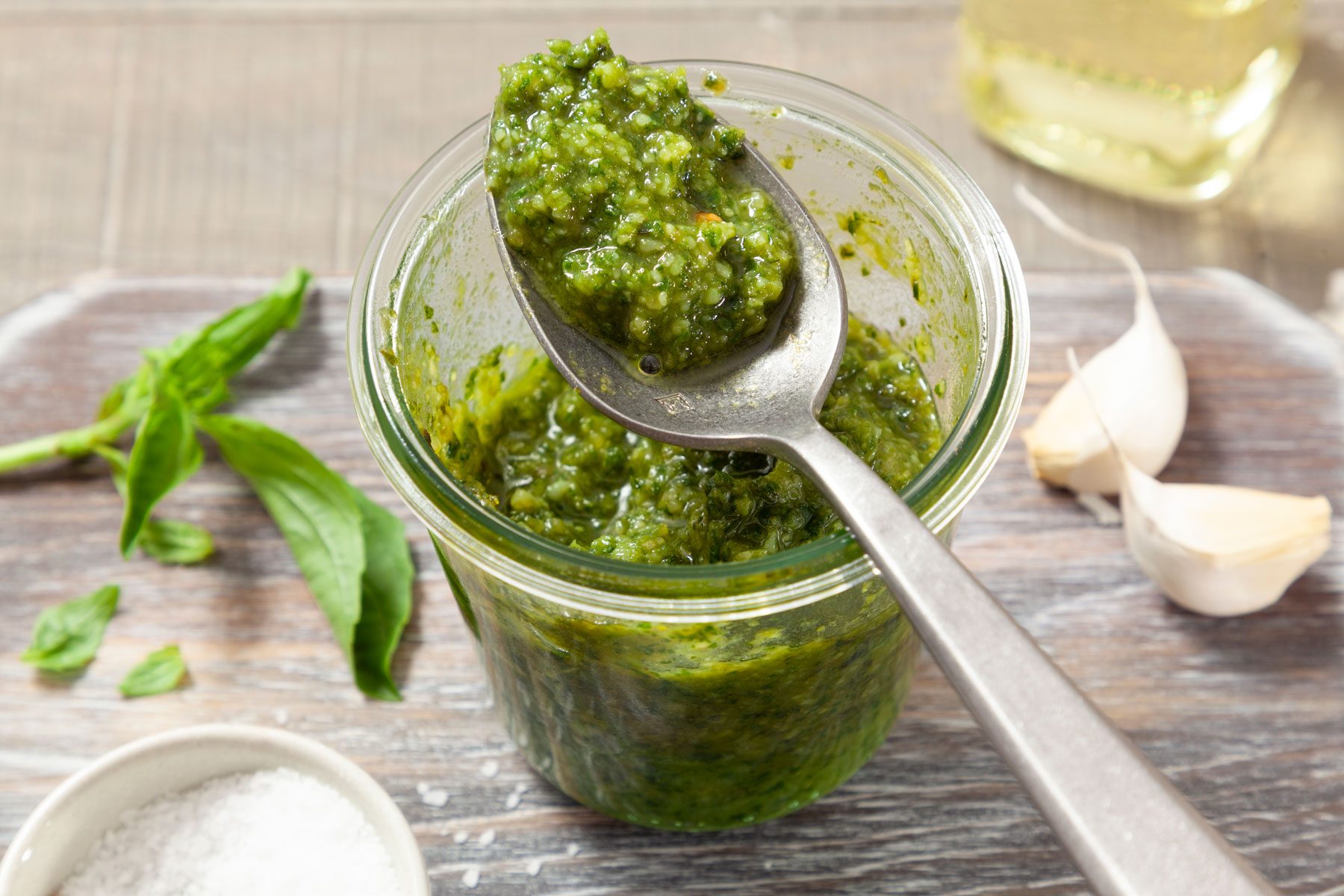 Classic Pesto in a small jar on a wooden surface