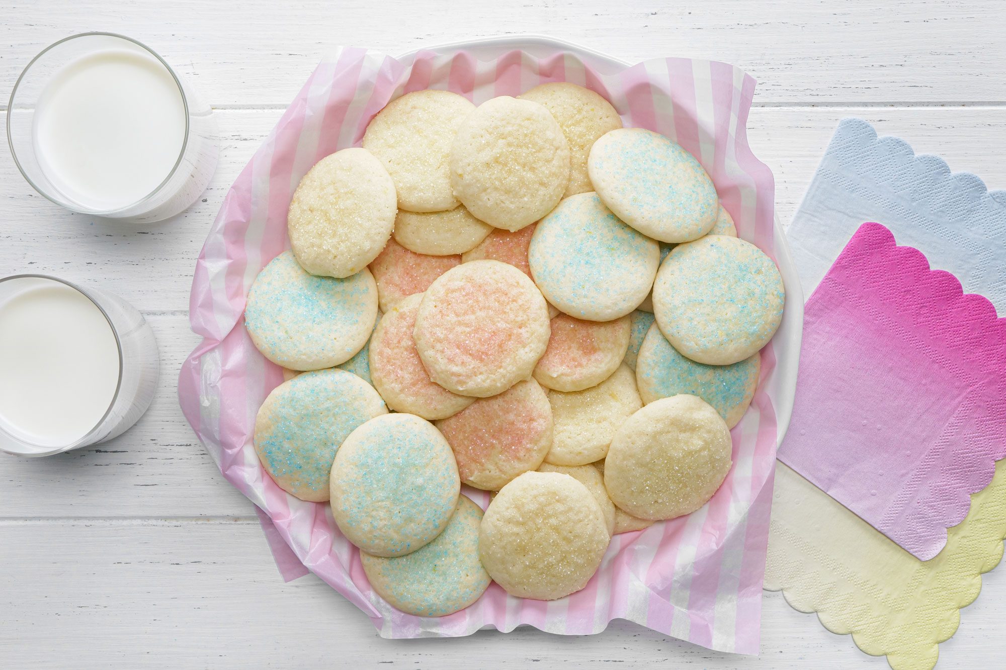 Drop Sugar Cookies served in a plate with two glasses of milk