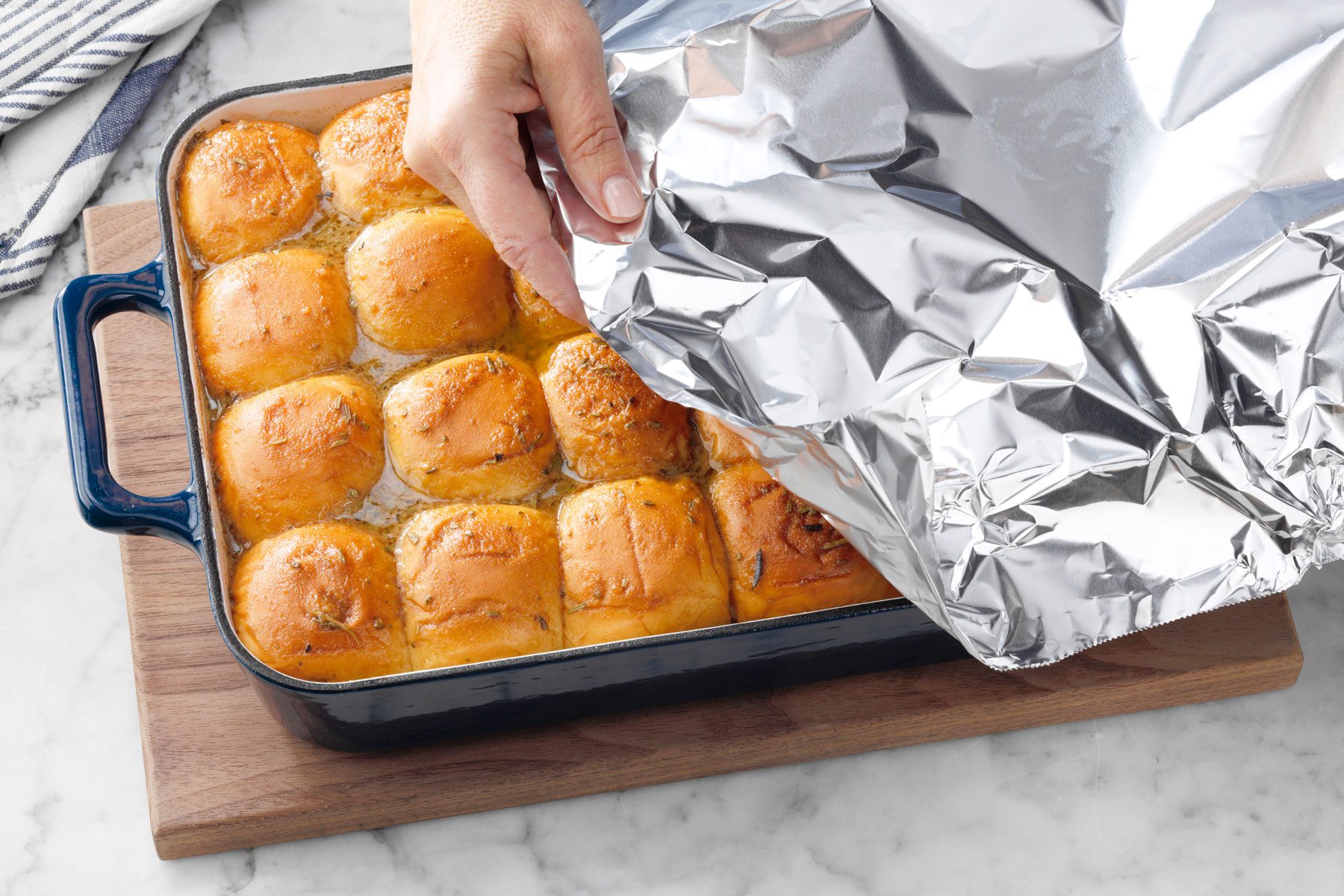 Covering the French Dip Sliders with foil paper before baking