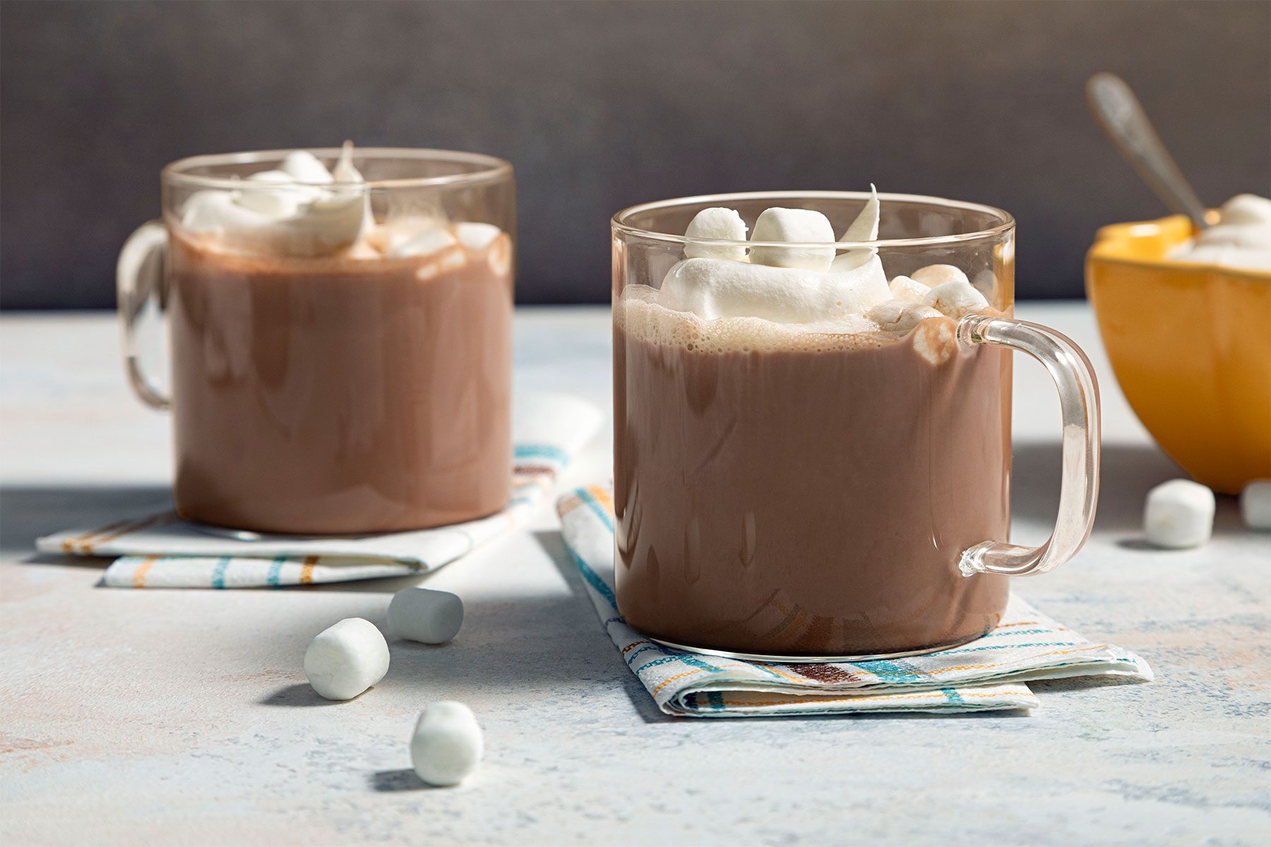 close shot of homemade hot cocoa served with marshmallows and cream