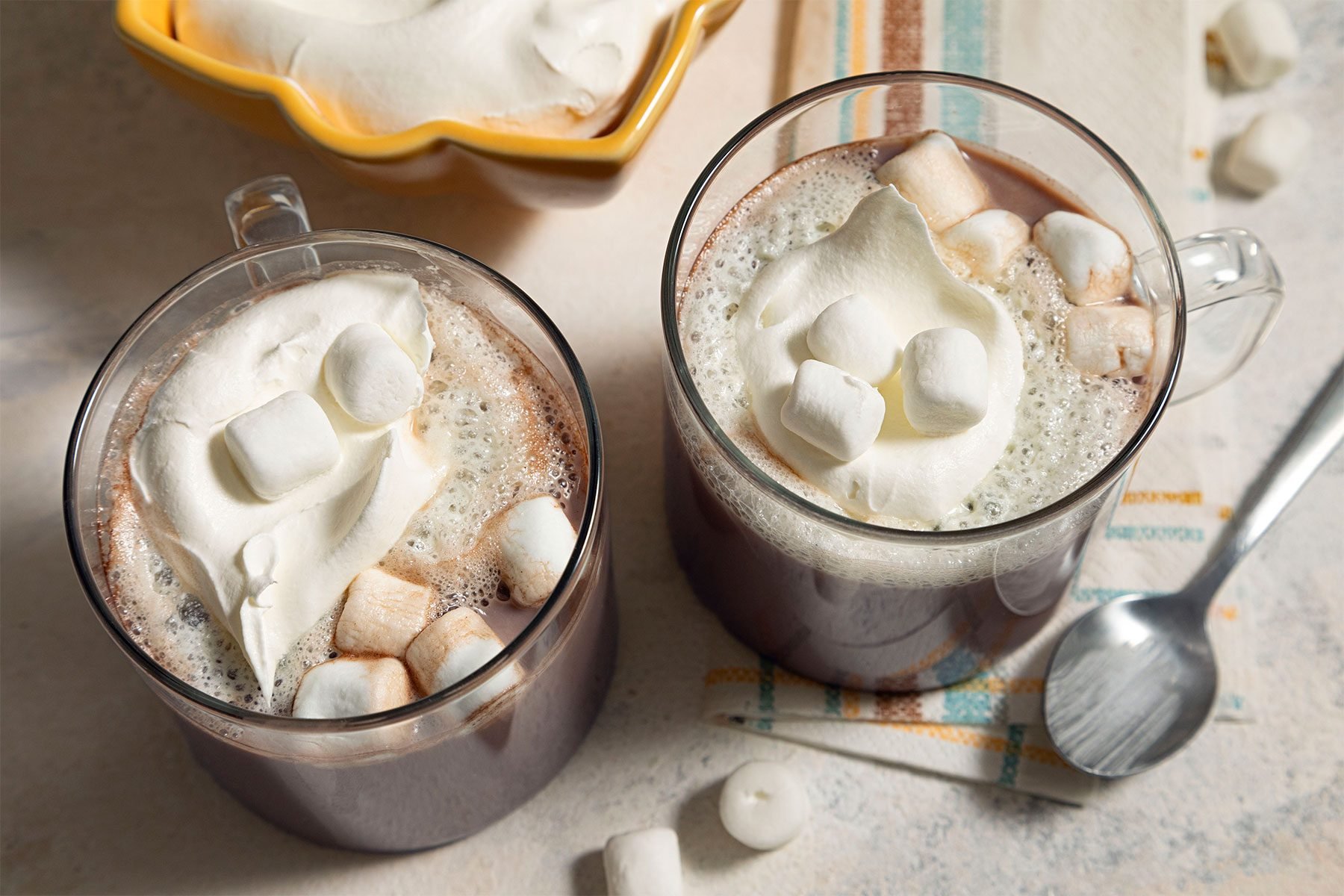 overhead shot of hot chocolate served with marshmallows and cream