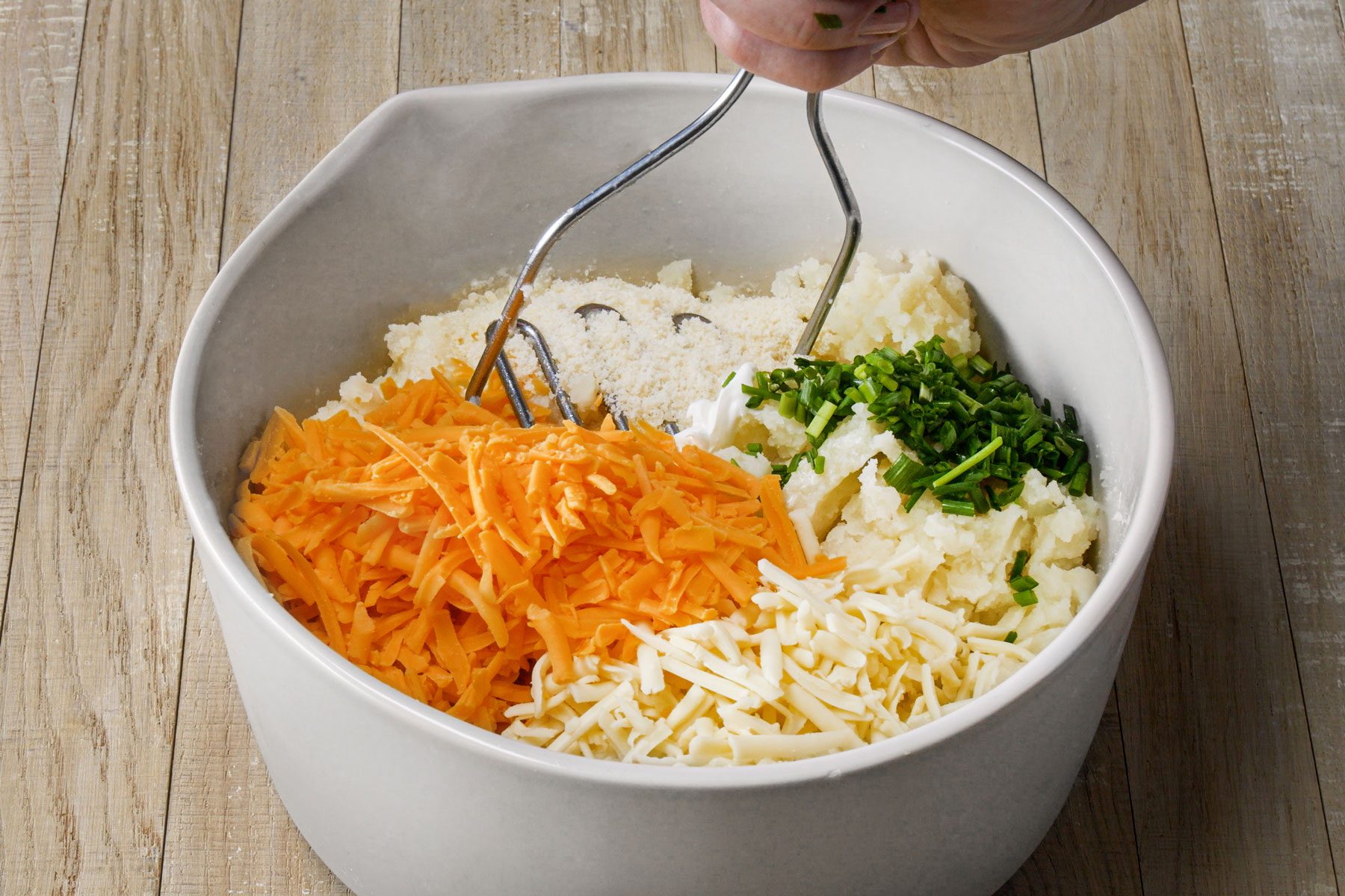 Potato pulp cheese and other ingredients mixed in a large bowl
