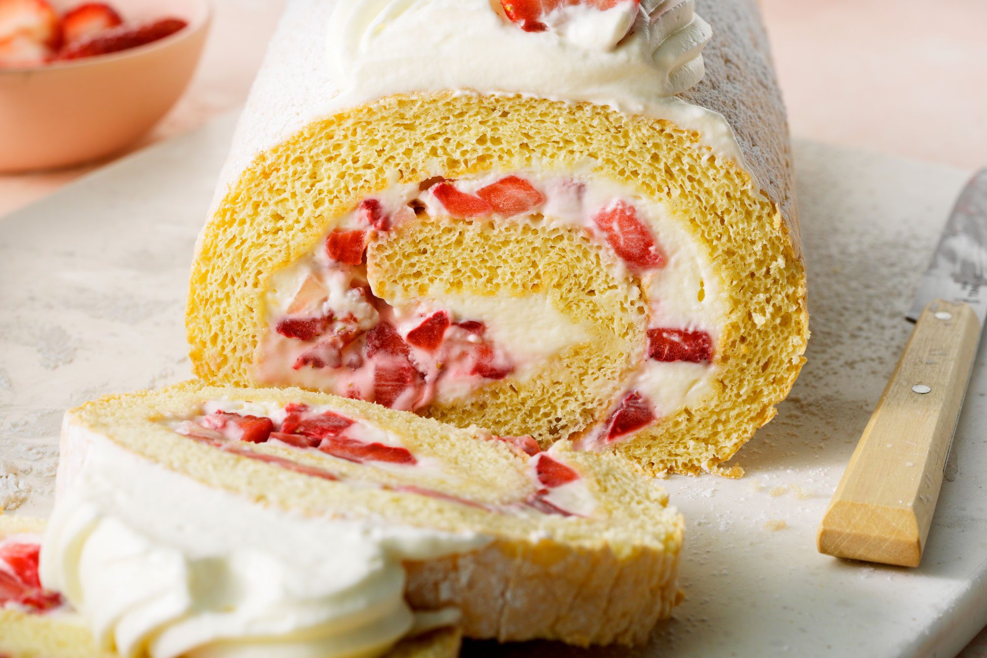 close shot; Strawberry Cream Cake Roll placed on white board;