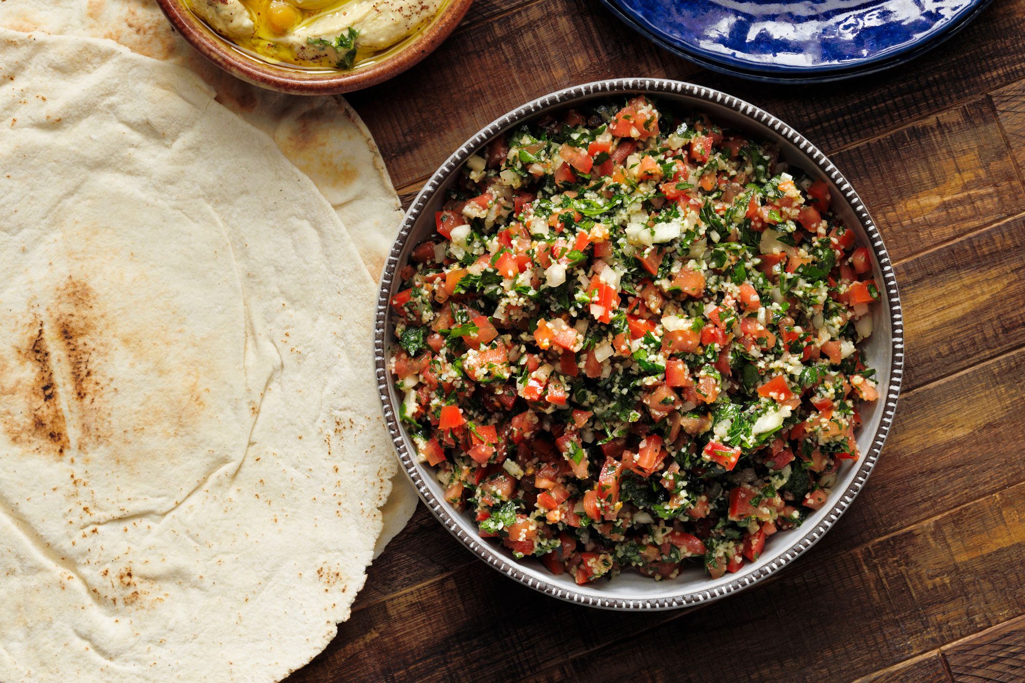 overhead shot of tabbouleh in a large bowl on wooden surface