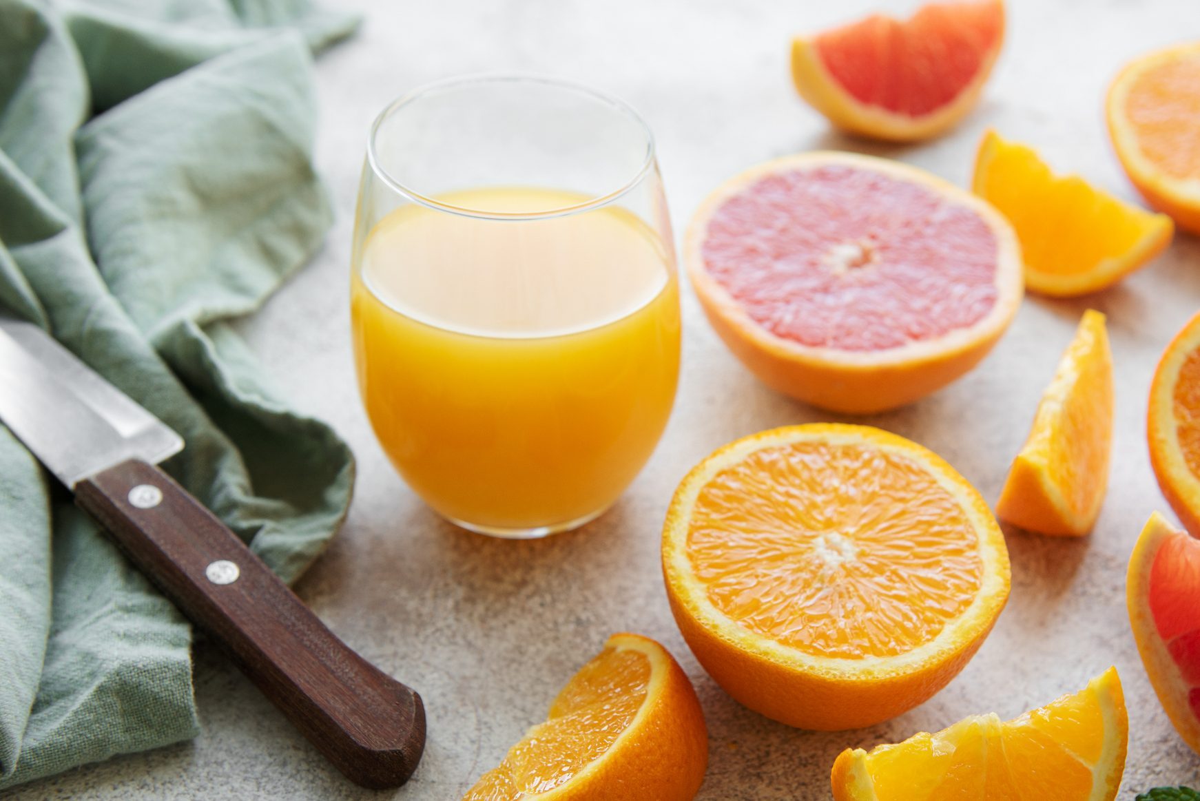 Glasses of juice and citrus fruits