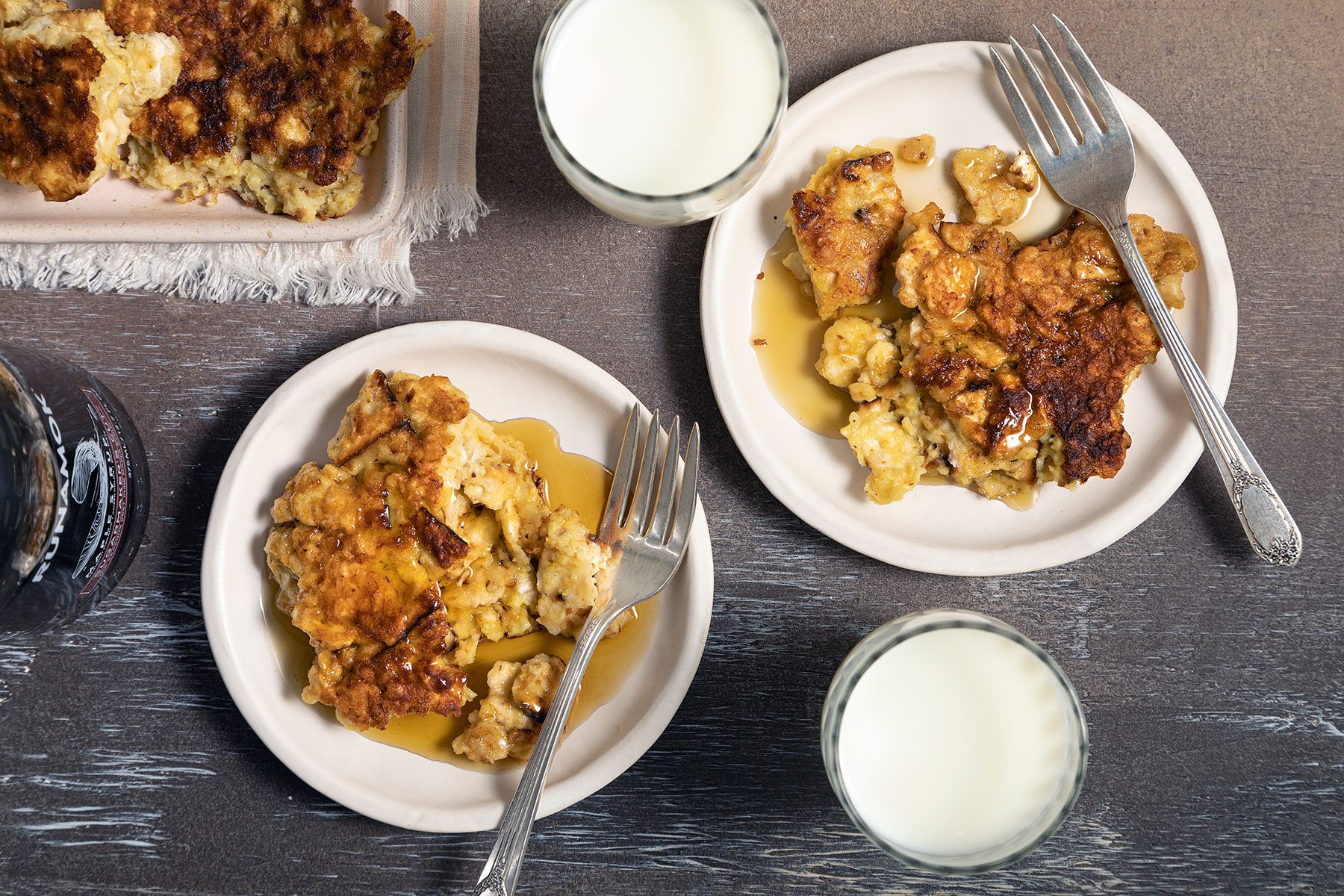 Cooked Matzo Brei served on plate with maple syrup