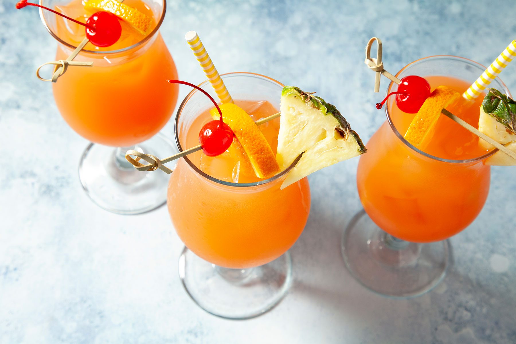 high angle shot of sweet rum punch garnished with fruits