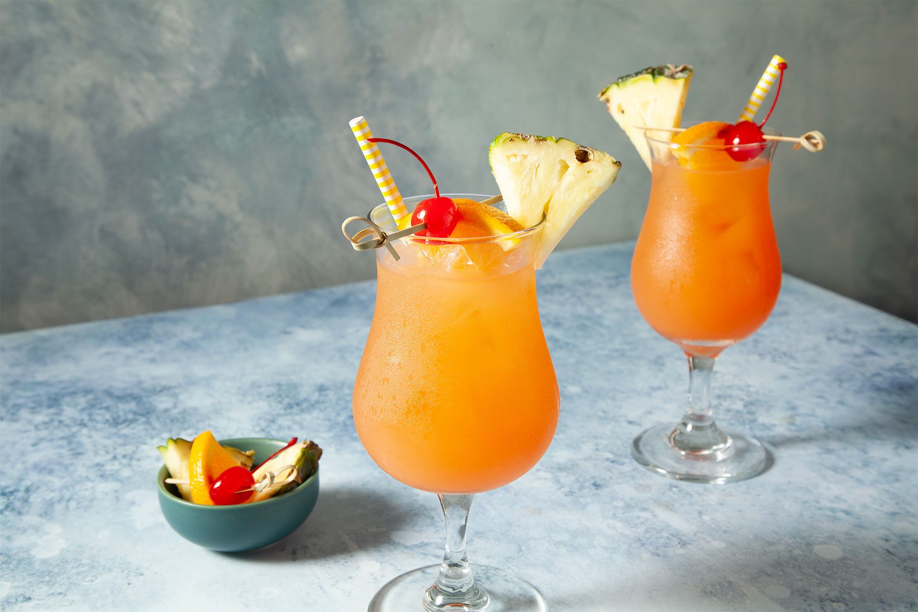 wide shot of sweet rum punch with fruits