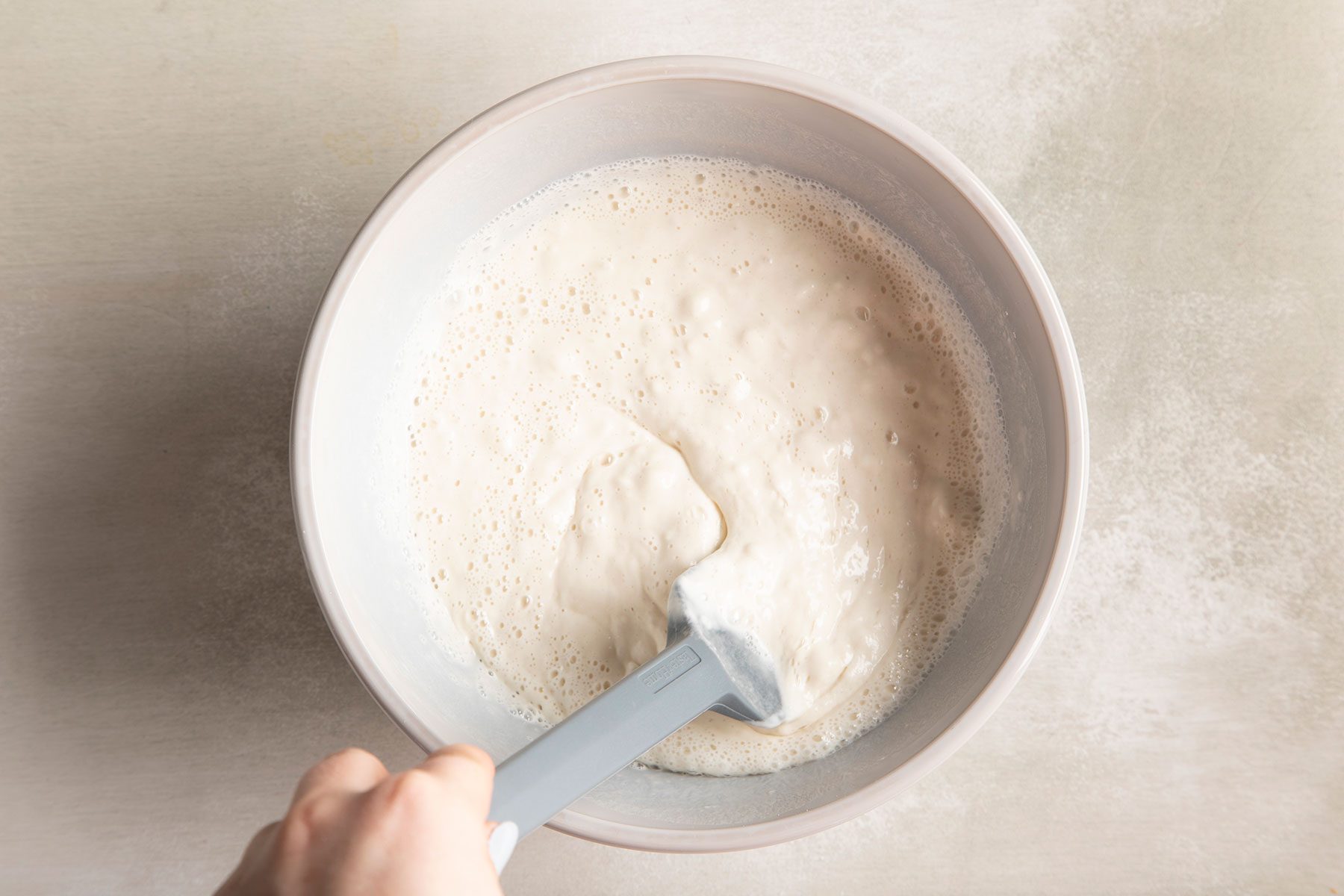 Stirring batter in a bowl for shrimp tempura.