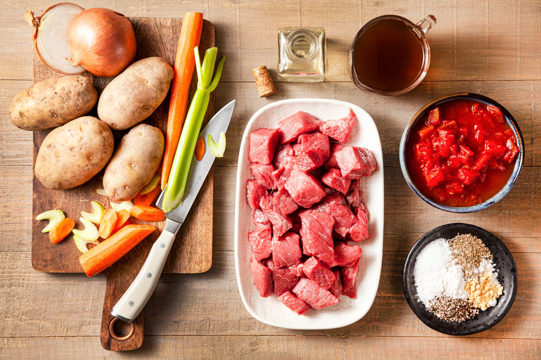 A table with slow cooker beef stew ingredients