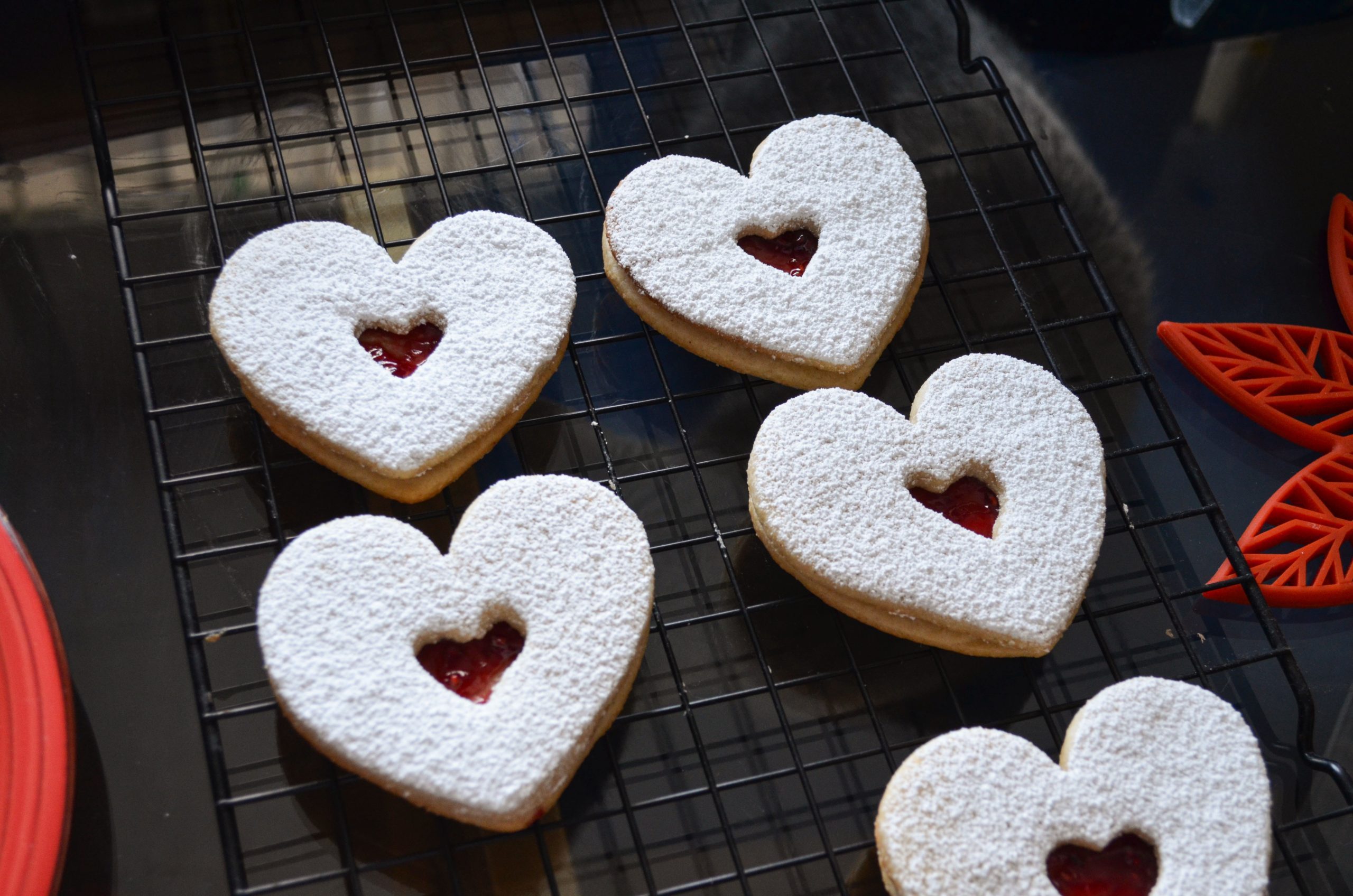 Linzer heart cookies served on a baking tray