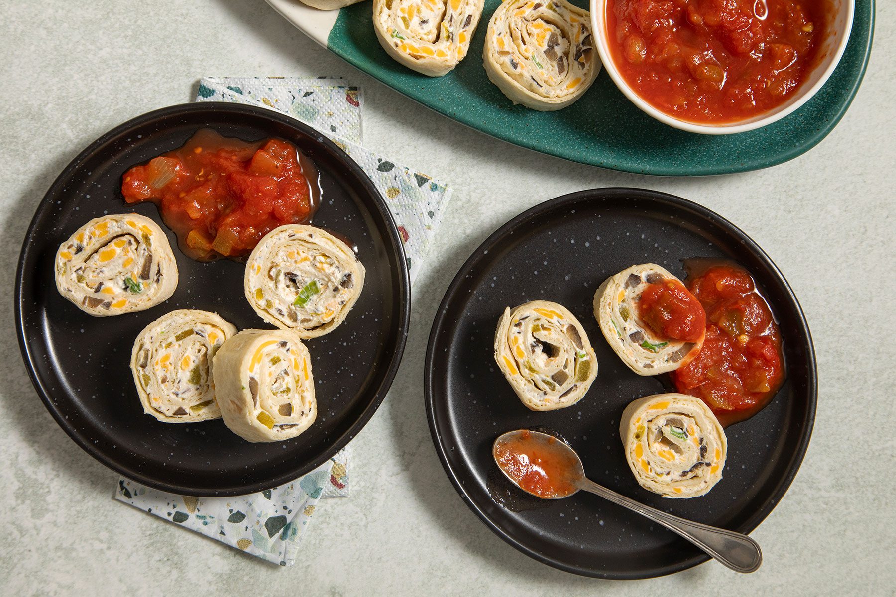 Appetizer Tortilla Pinwheels served on plates with salsa
