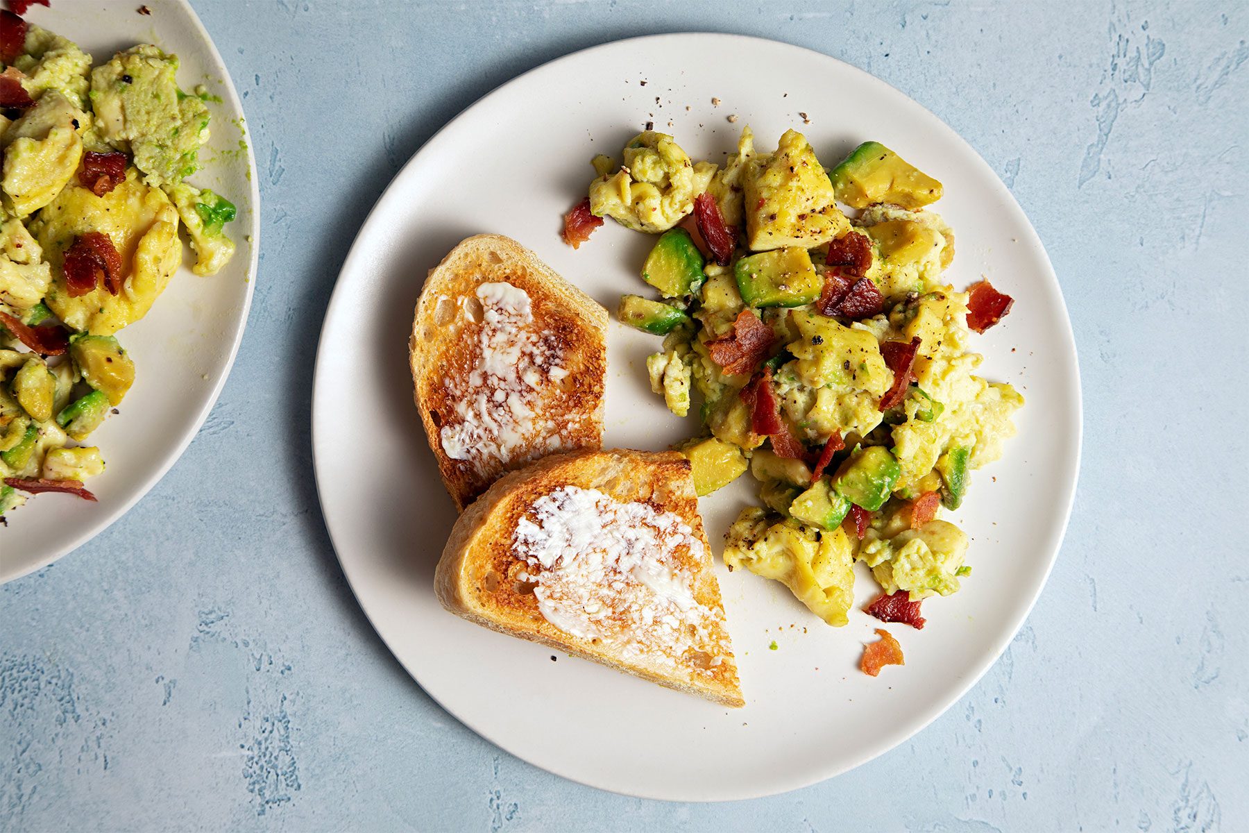 overhead shot of avocado scrambled egg served with toast