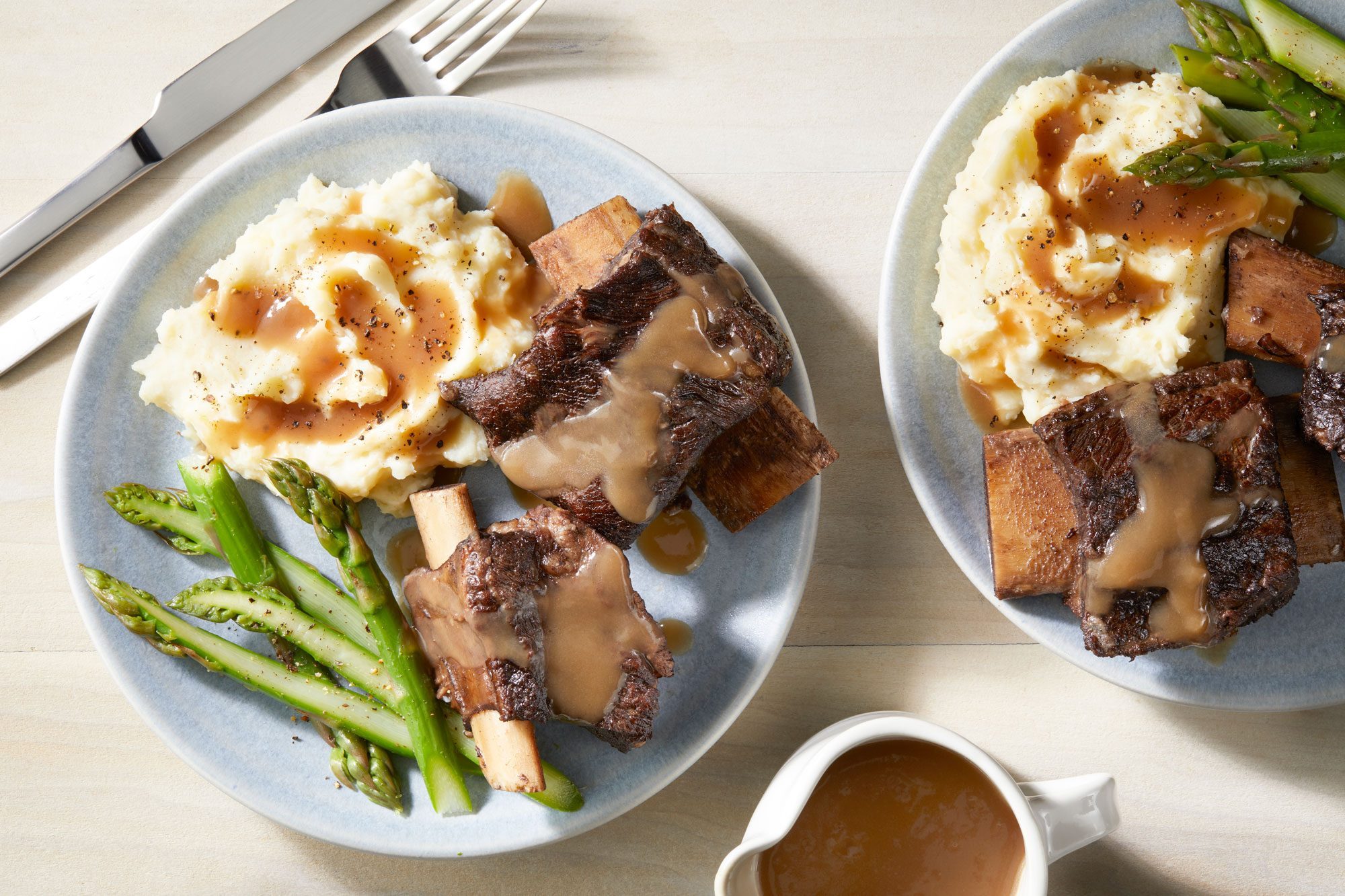 Braised Short Ribs served in two plates with celery