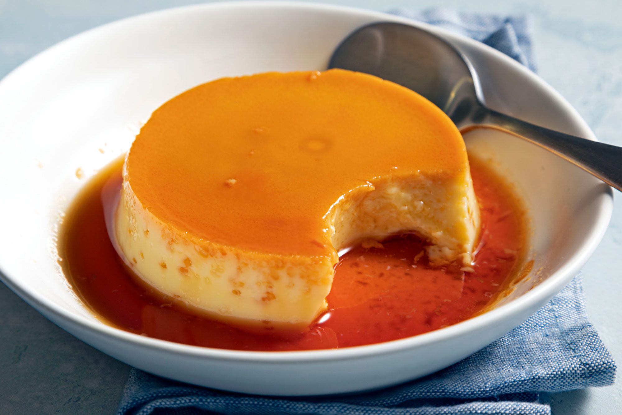 Caramel Custard served in a bowl with sauce