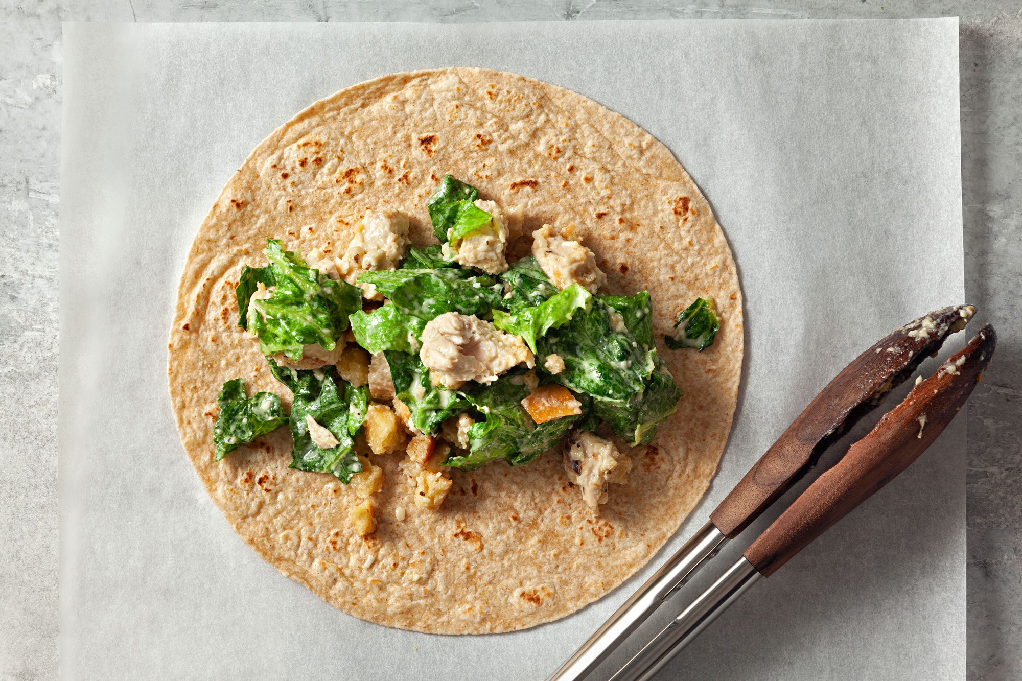 overhead shot of chicken mixture rolled on a tortilla