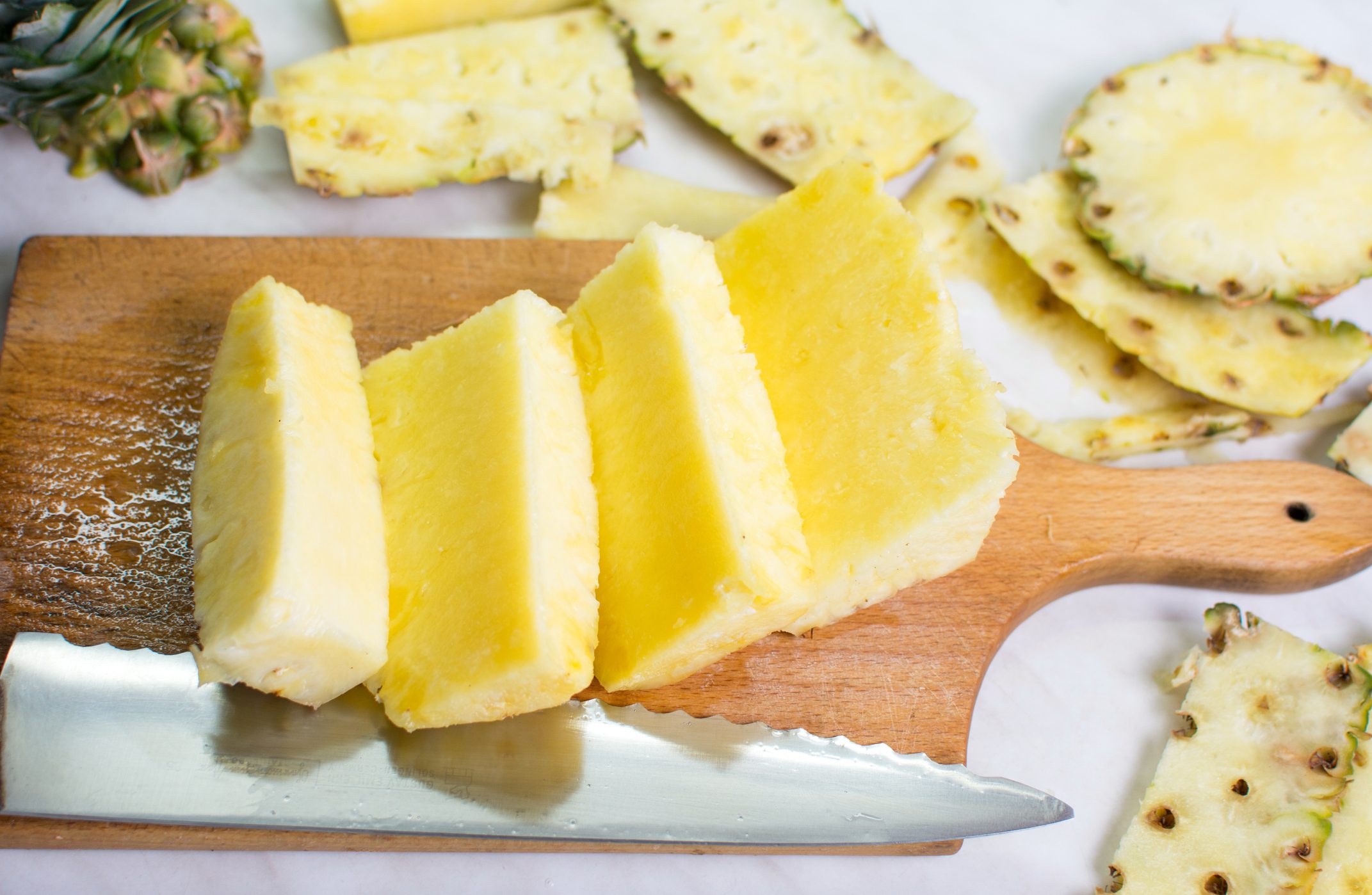 Sliced pineapple fruit on a board