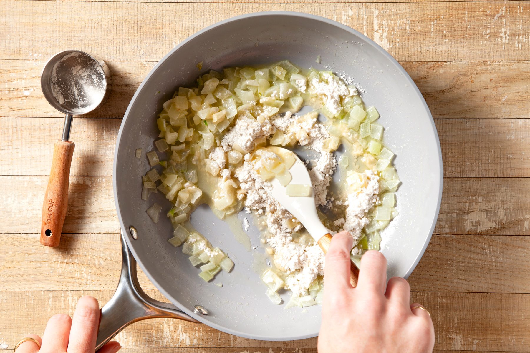 overhead shot of onion cooked in butter in a large skillet