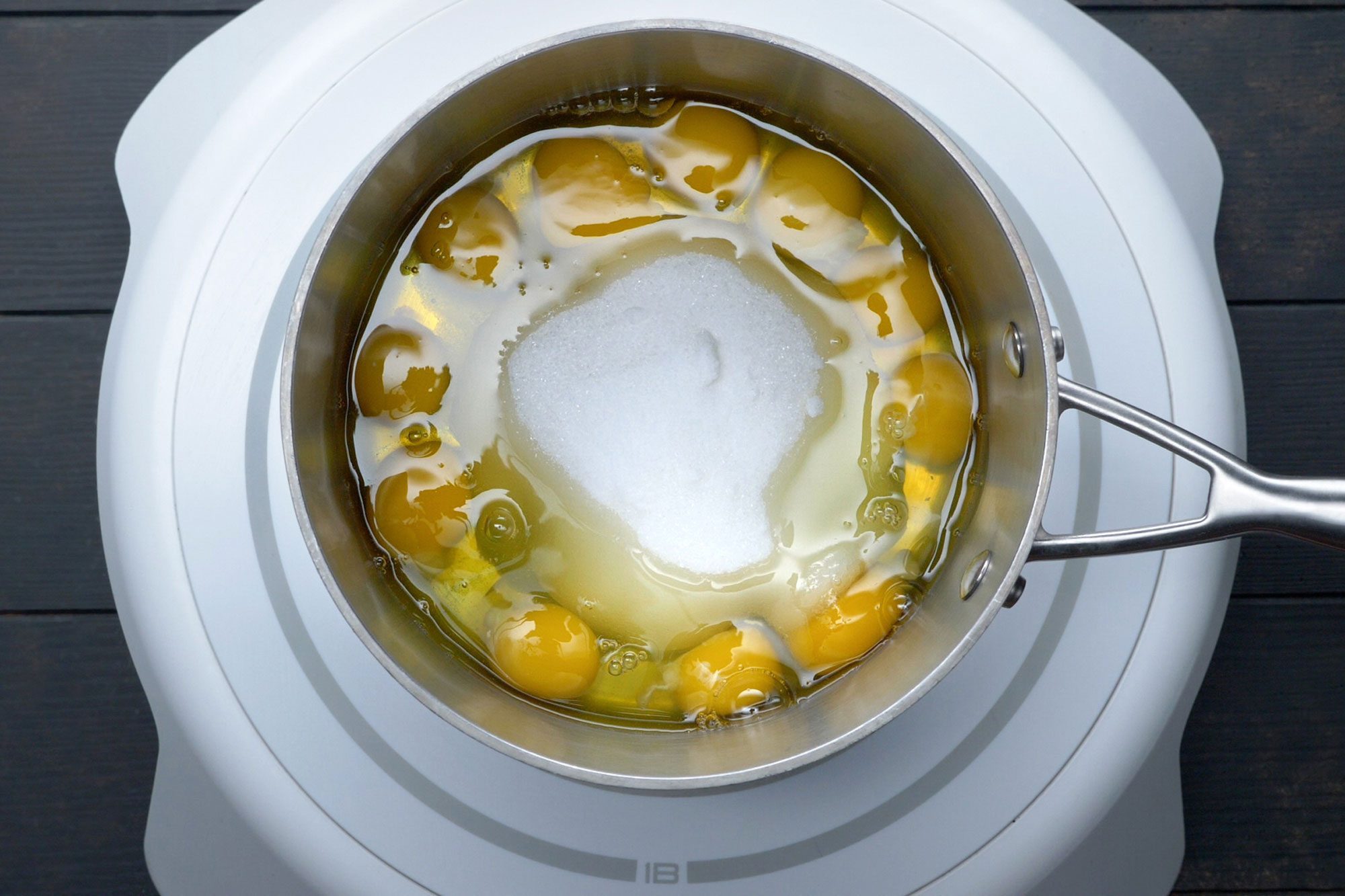 overhead shot of eggs, sugar and salt in a large saucepan