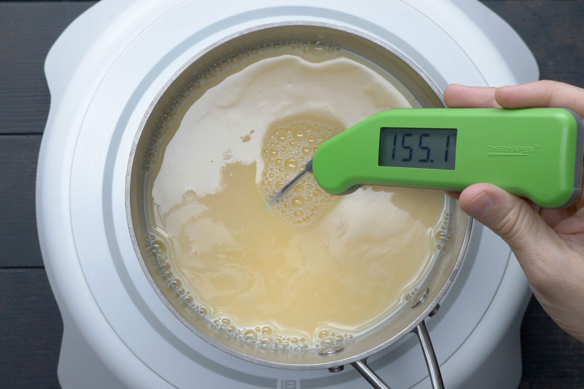 overhead shot of thermometer reads 155° temperature of the egg mix