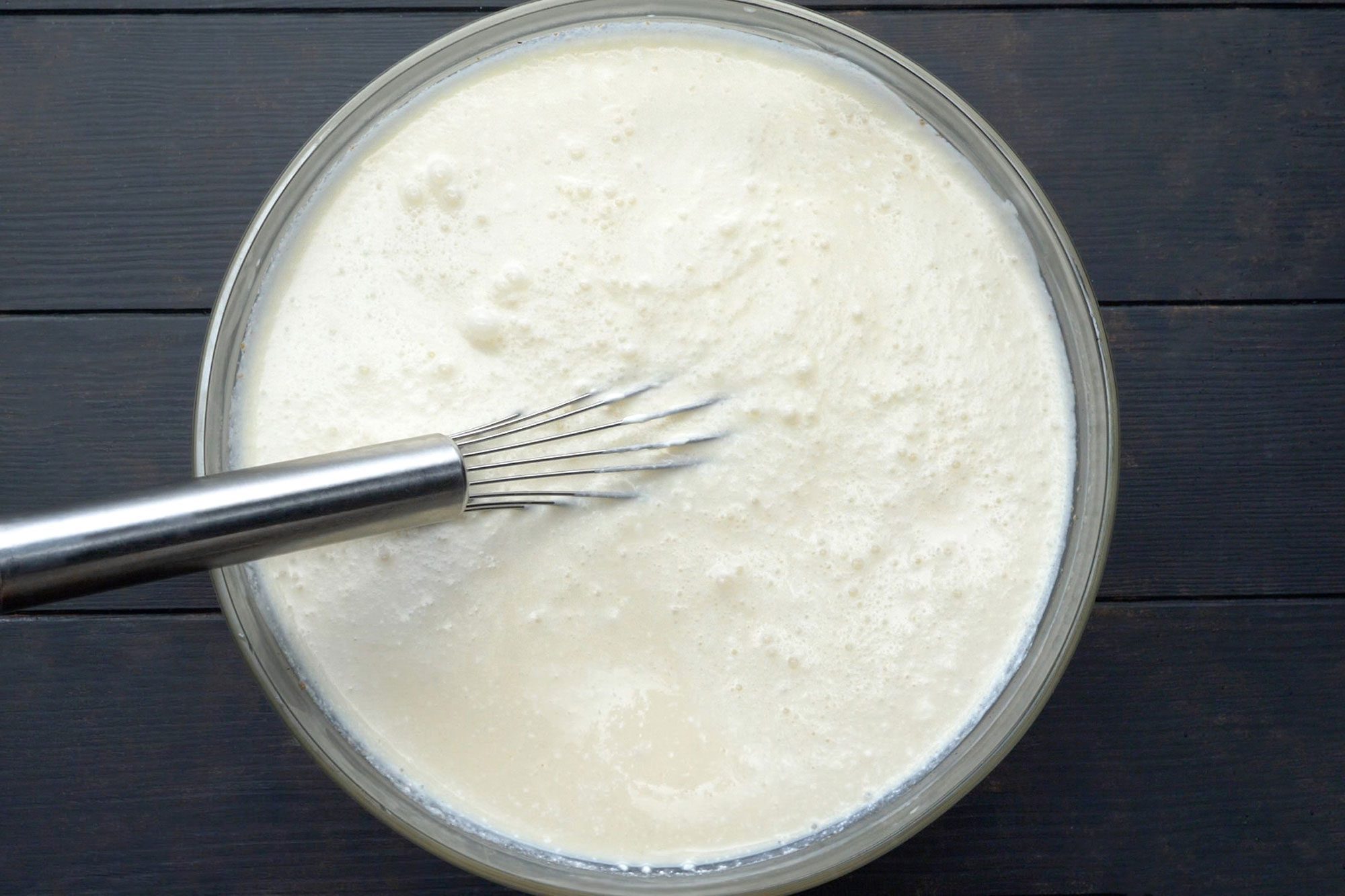 overhead shot of whisked egg mix in a large bowl