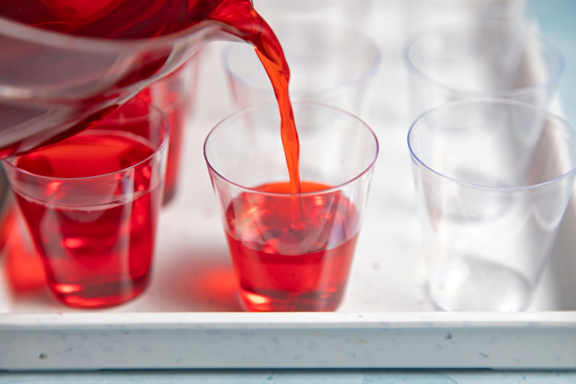 close shot of cherry mix poured into shot glasses