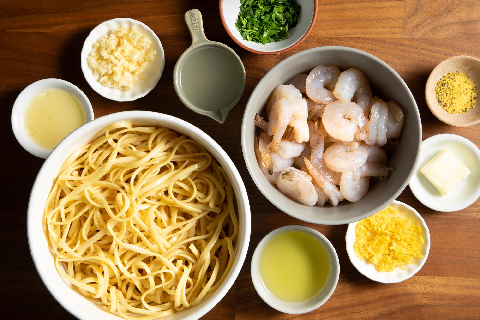 overhead shot; wooden background; Garlic-Lemon Shrimp Linguine ingredients;