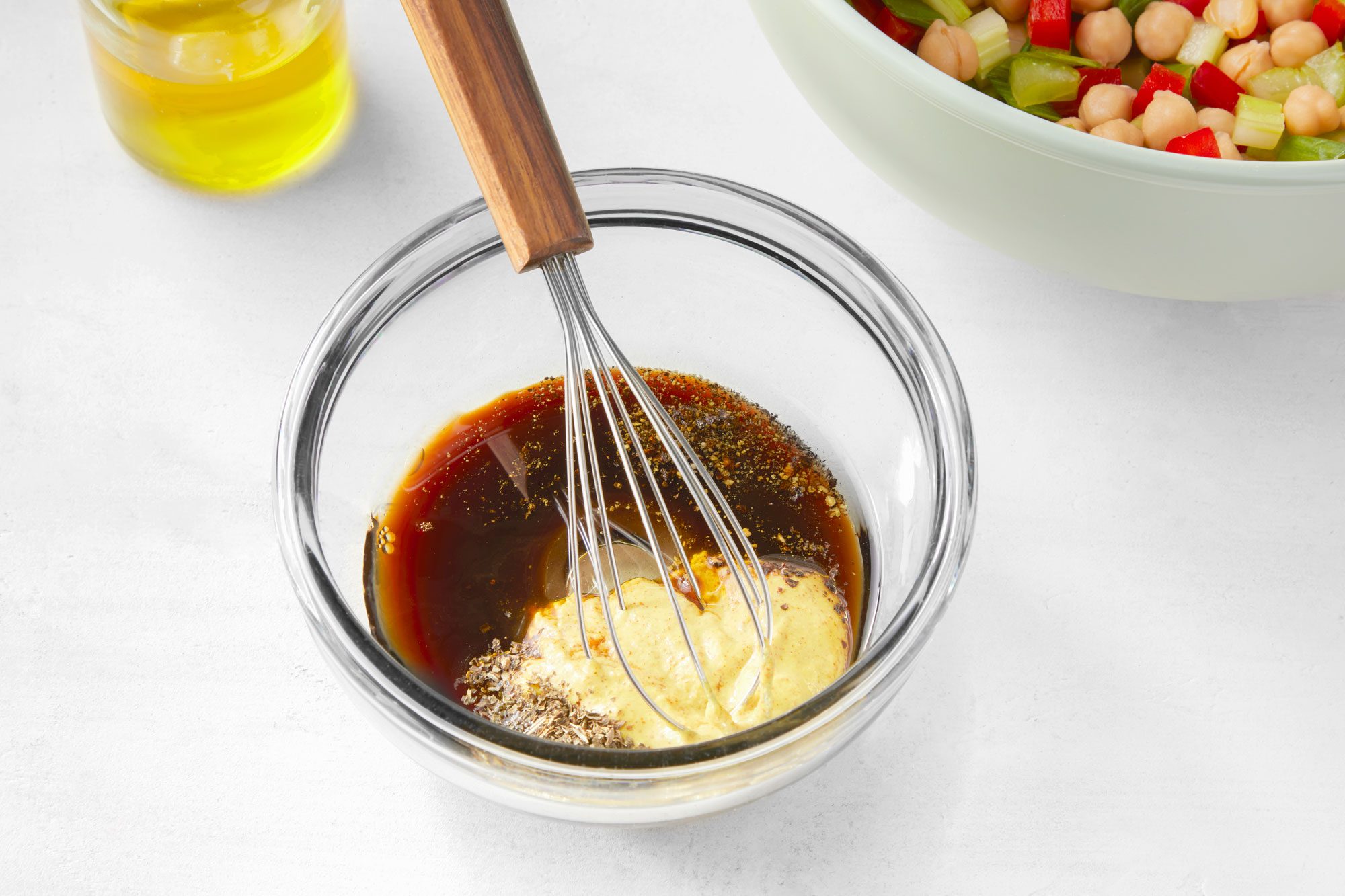 Whisk the oil, vinegar, mustard, basil, salt and pepper in a small bowl