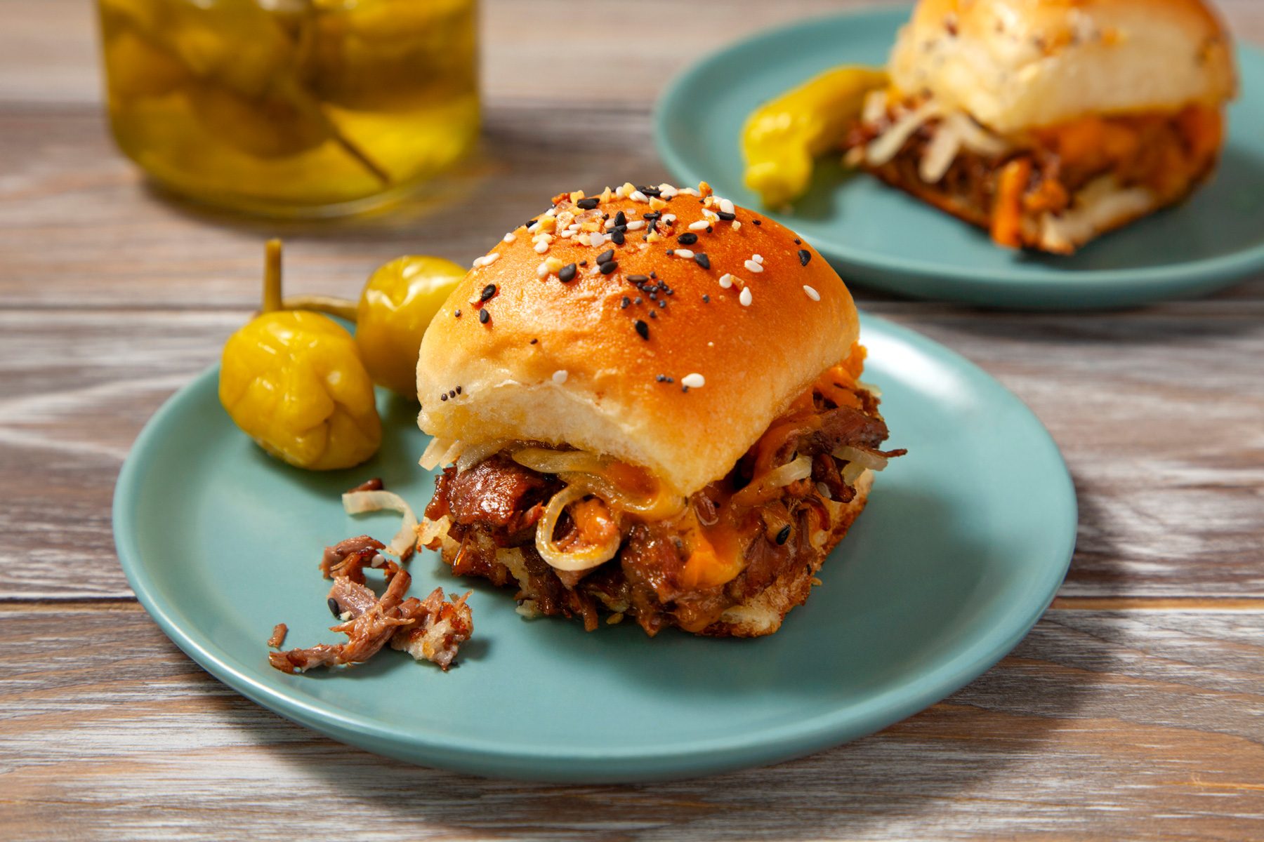 A plate of roast beef sliders on a table