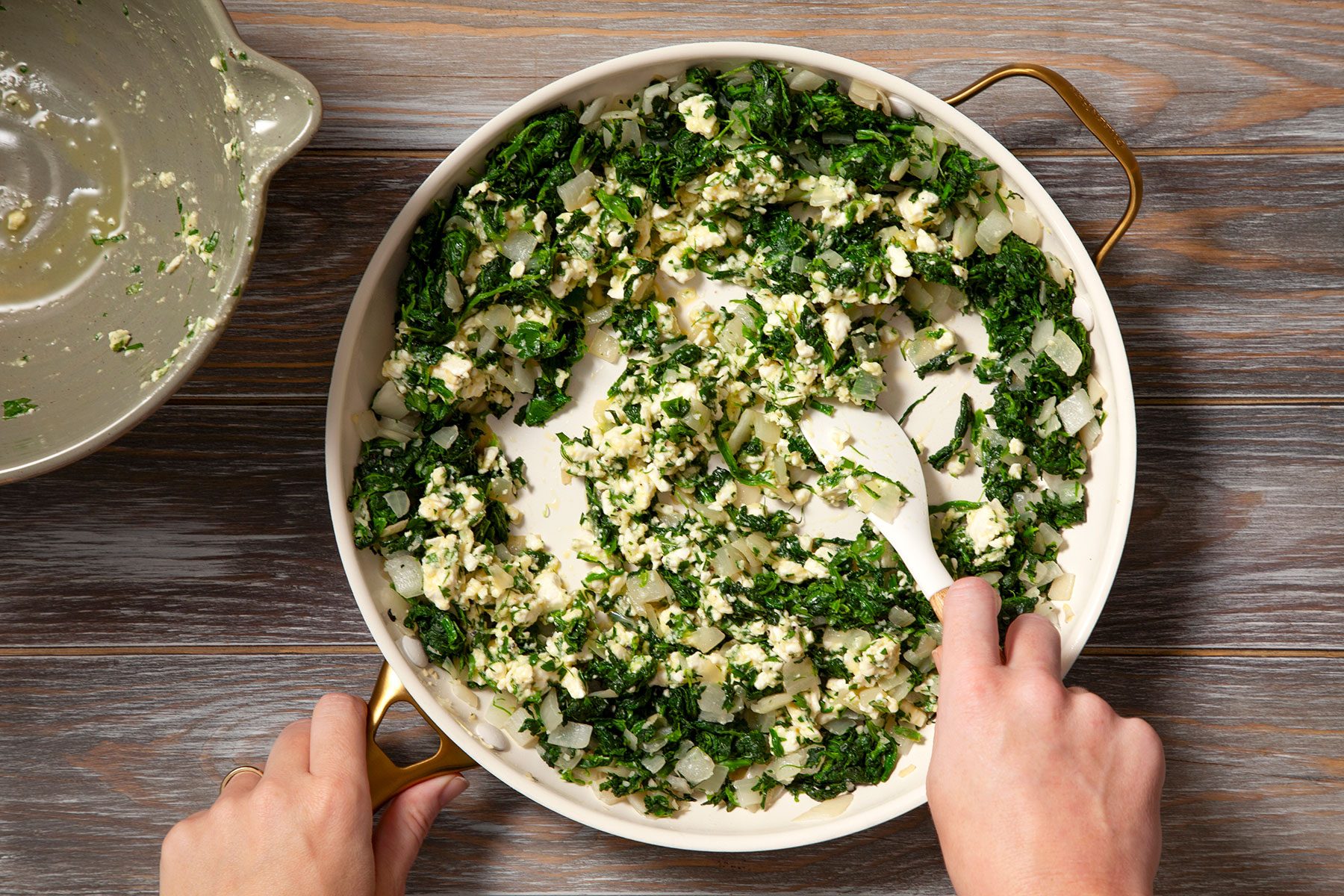 Mixing the wet ingredients with onions and spinach